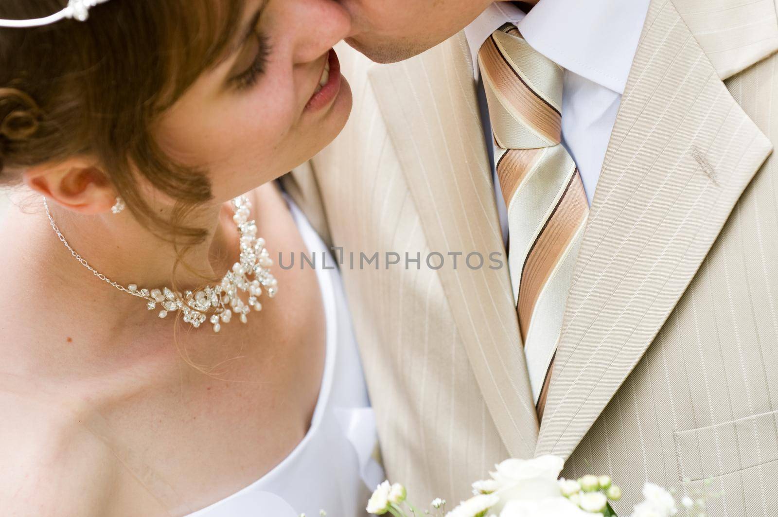 Newlyweds kissing after a wedding ceremony.