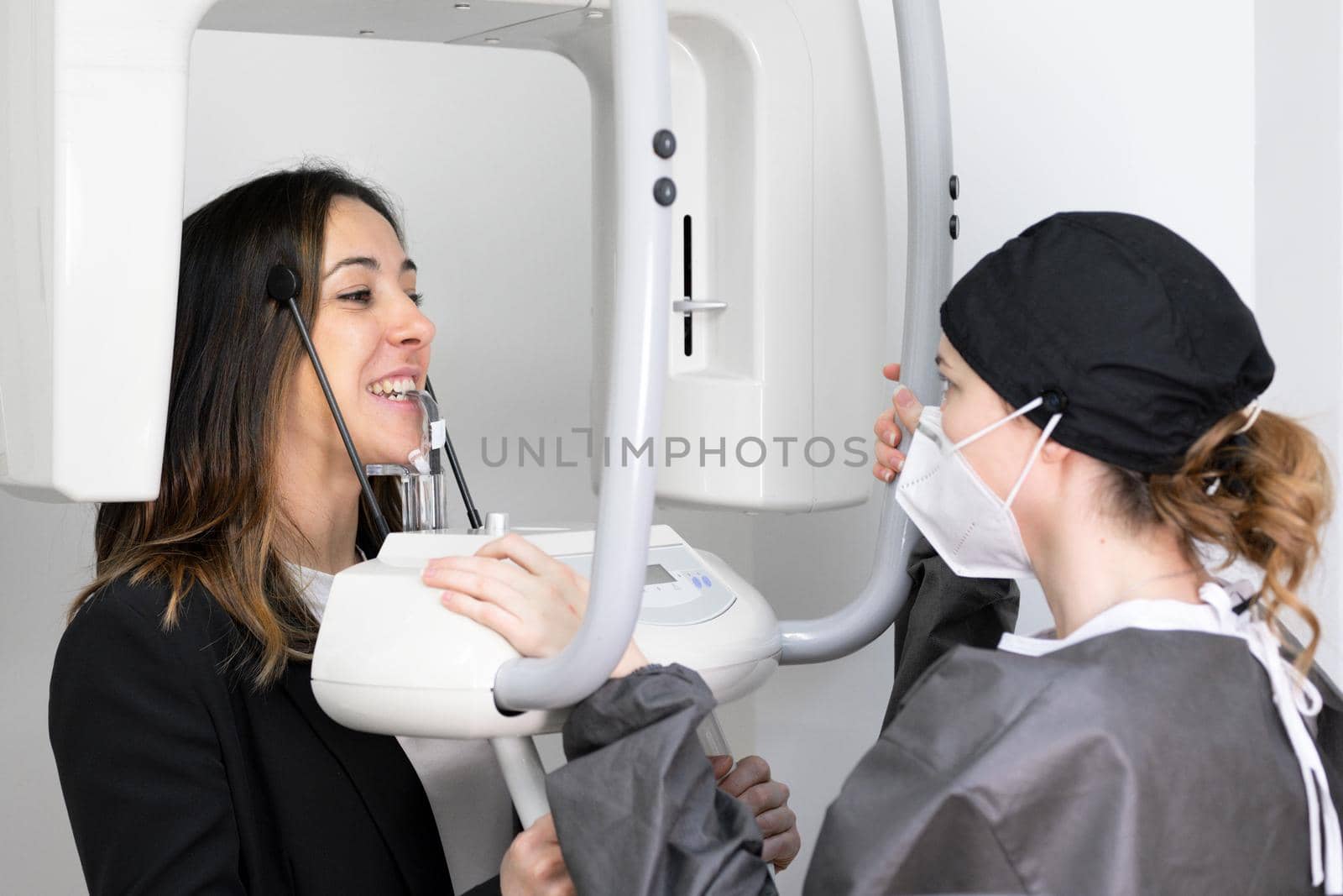 Young woman patient standing in x-ray machine. High quality photo