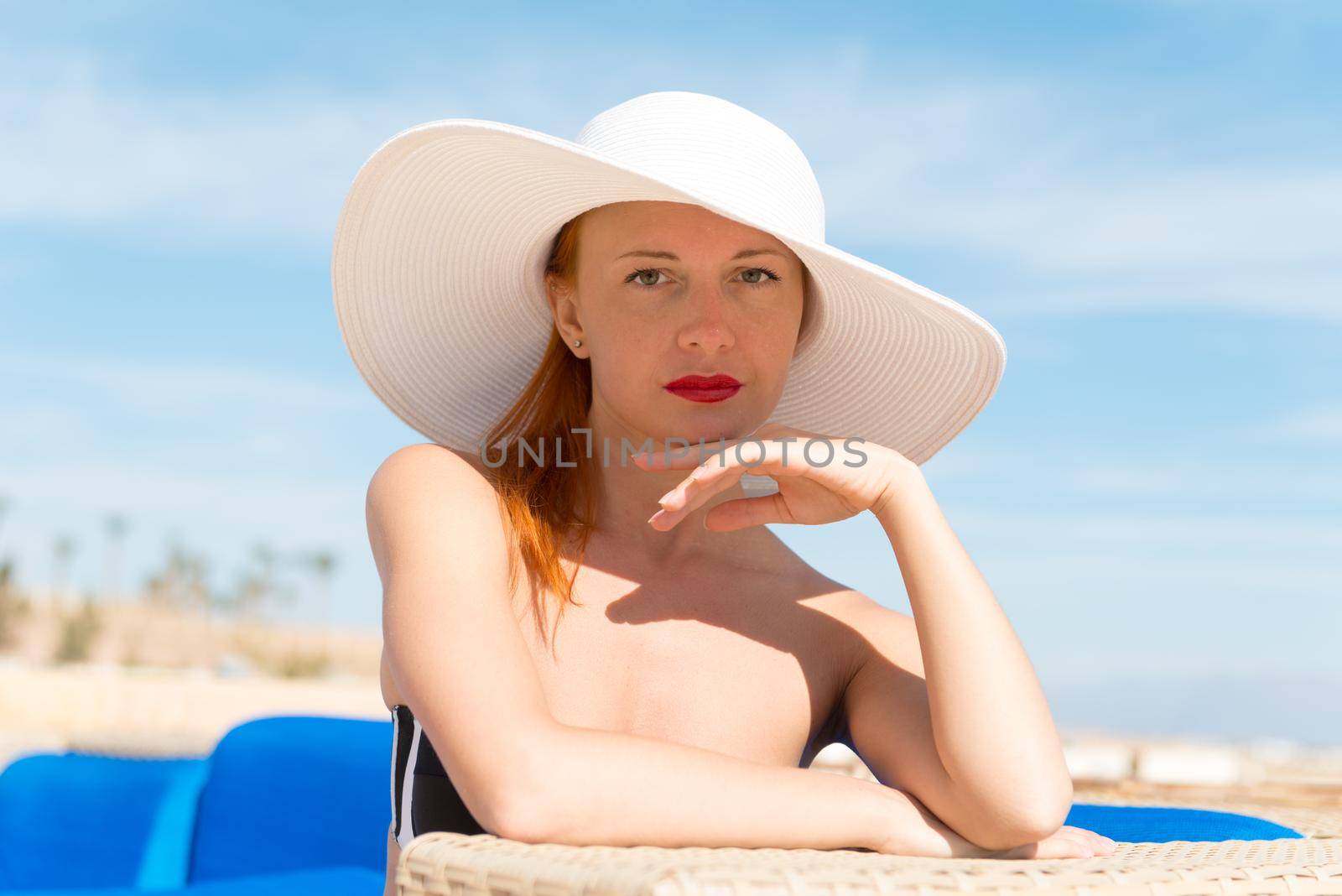 Beautiful sexy woman wearing white hat enjoying vacation closeup portrait