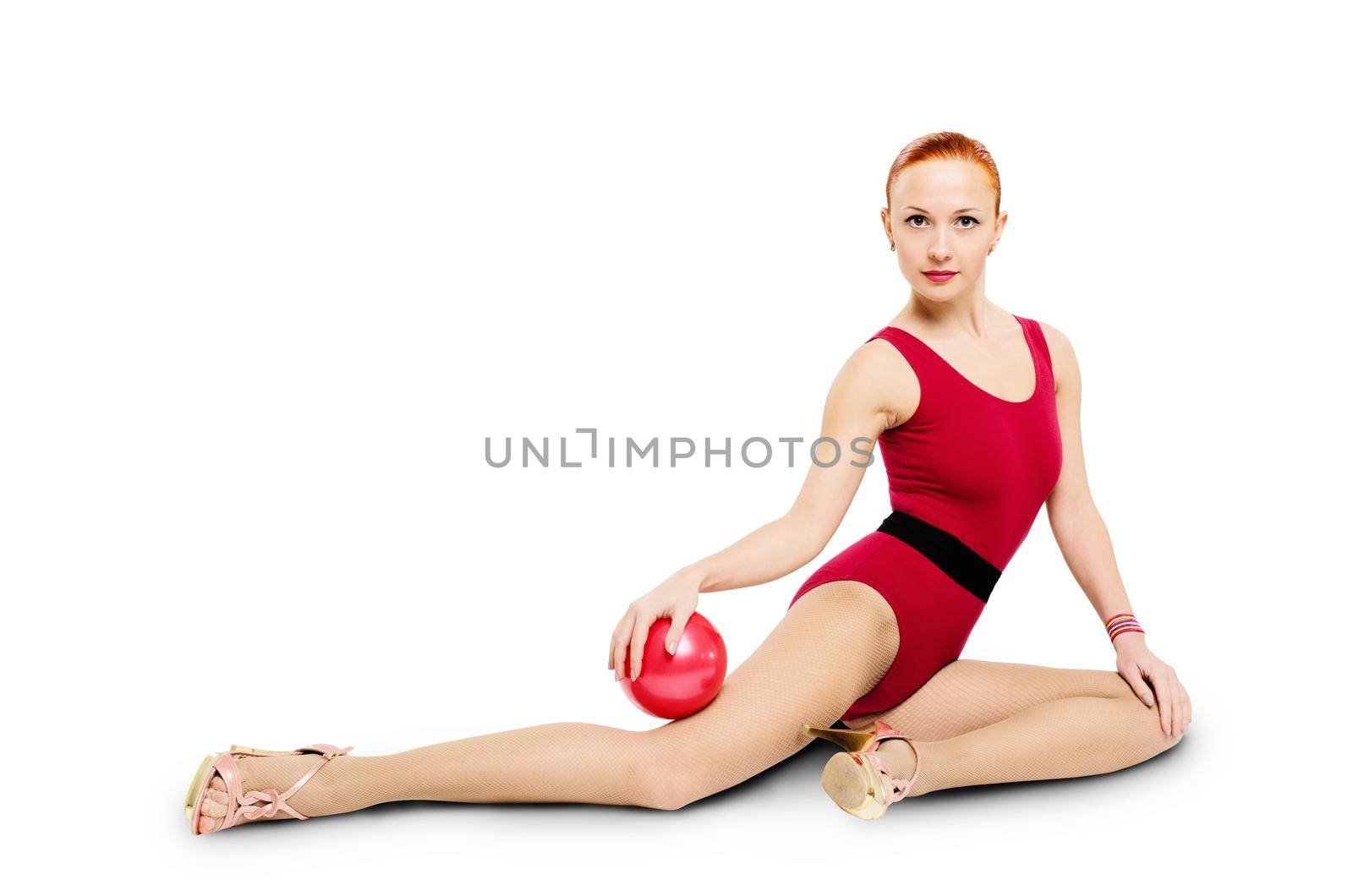 Beautiful fitness model posing with fit ball wearing high heels