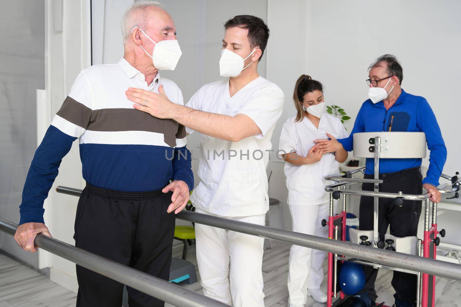 Group of Physical therapists working in rehab center, helping patients. High quality photo