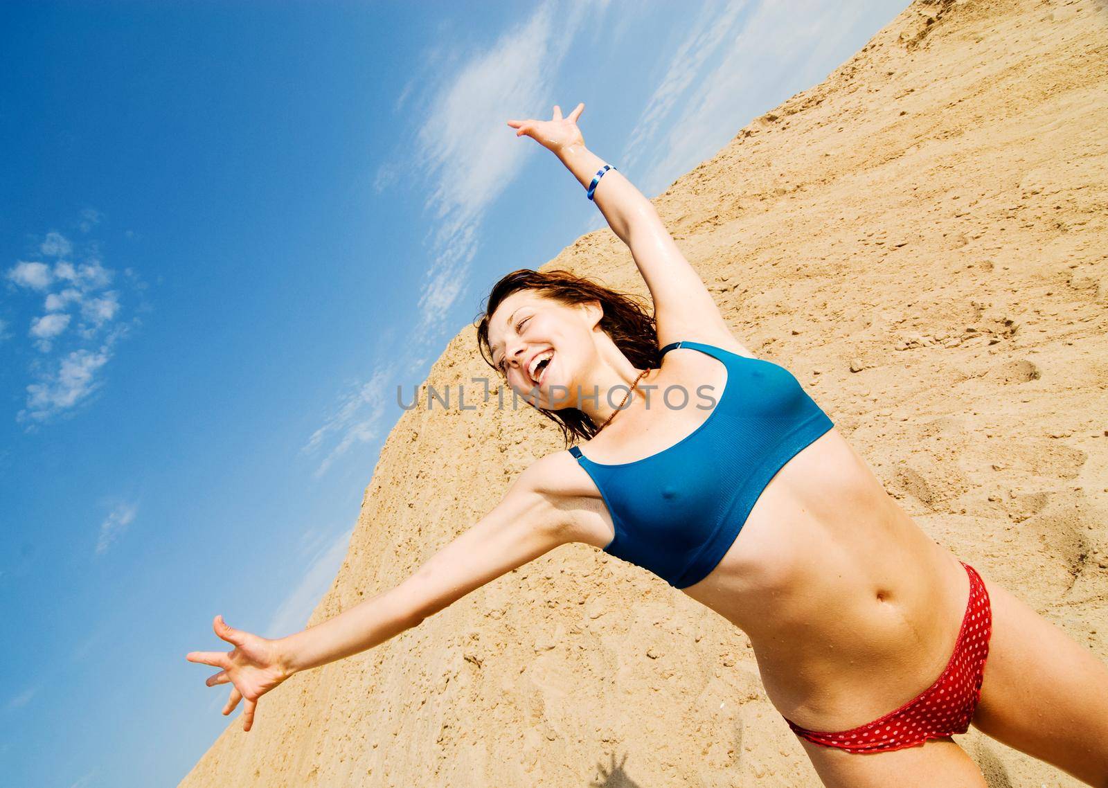 Young healthy-looking girl is excited about summer on a beach