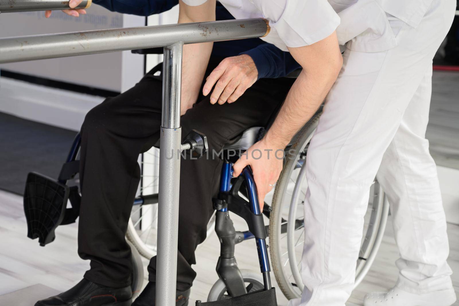 Senior Man Being Assisted By Physiotherapist In Rehab Center. High quality photo