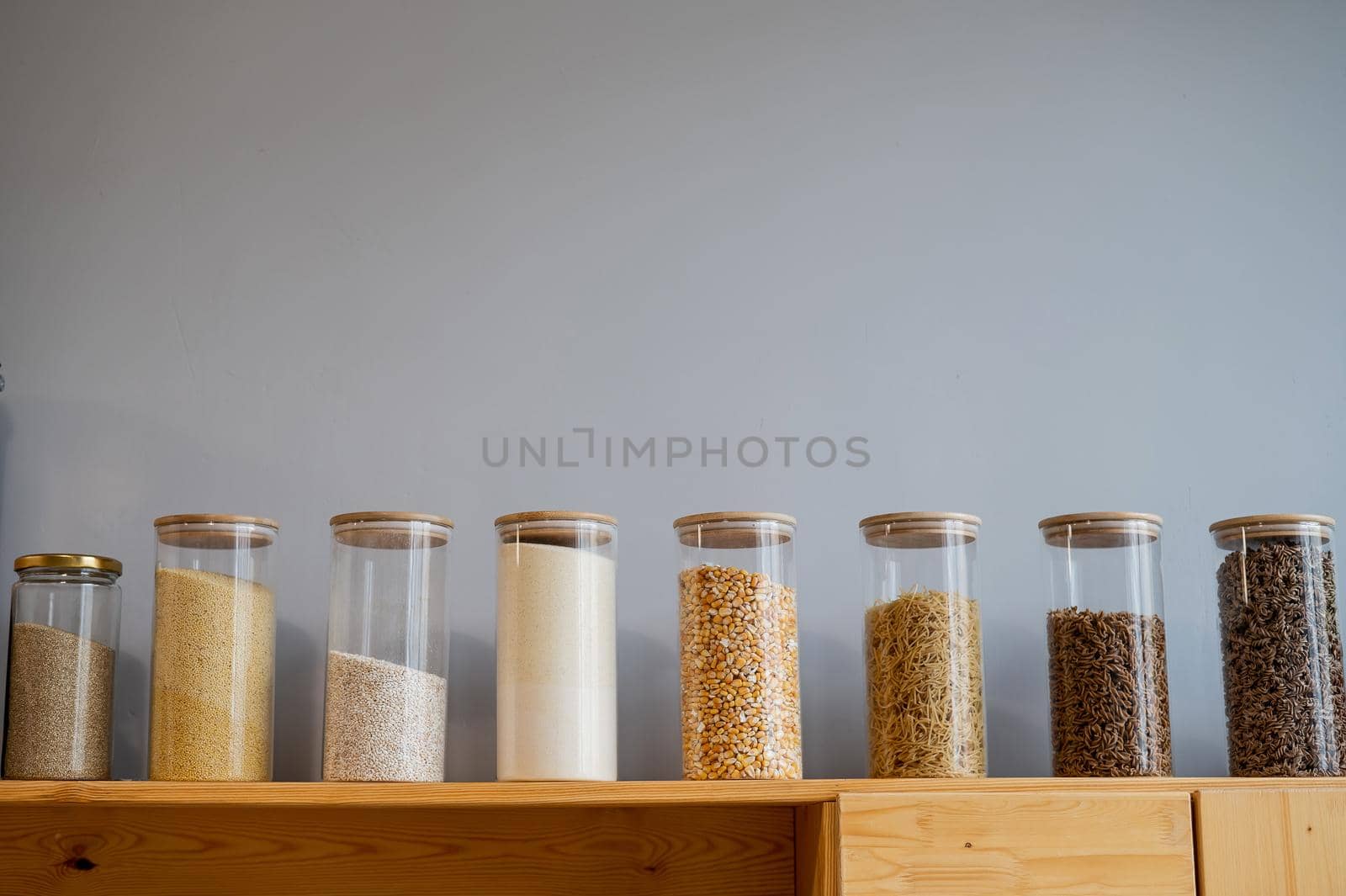 Glass jars with cereals in an eco friendly store. The concept of a grocery store without plastic disposable packaging.