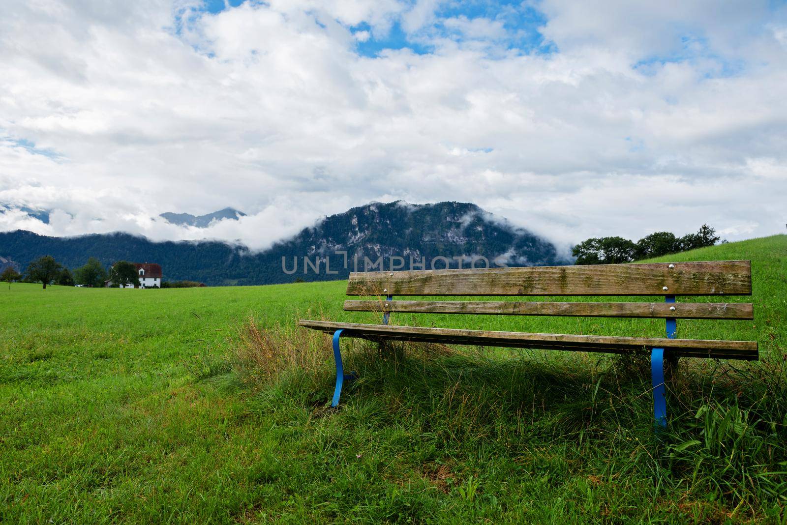 A calm place to rest and relax. An empty wooden bench. Switzerland by anytka