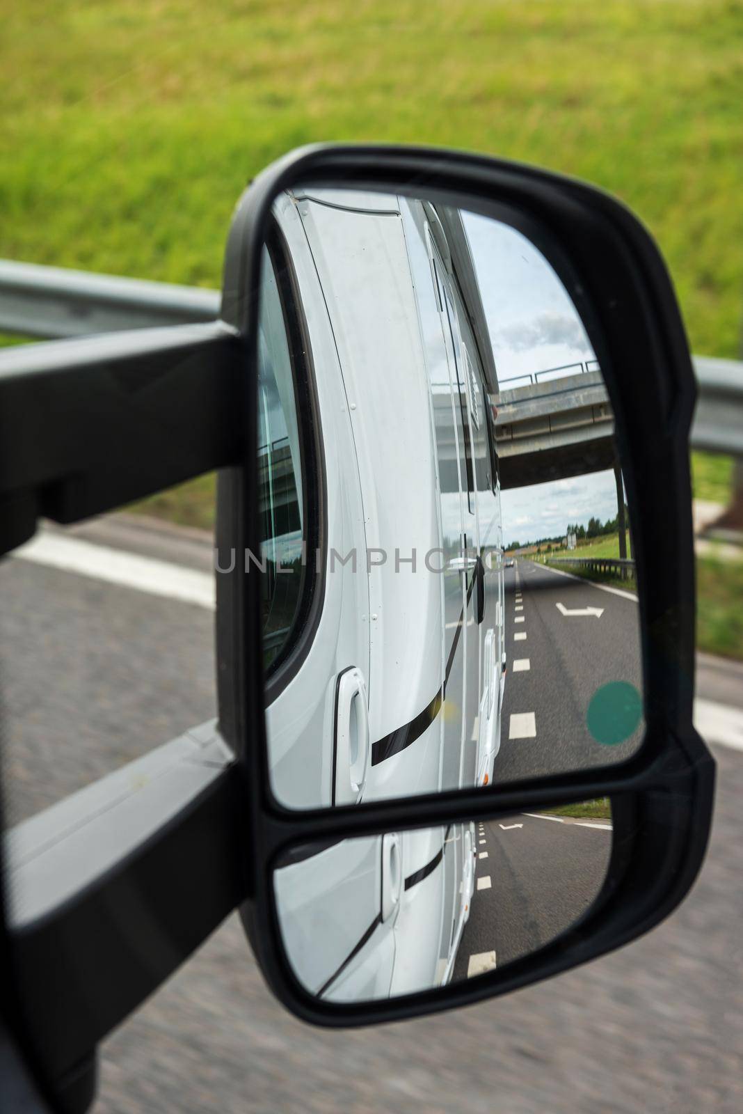 Road view from the side mirror. Traveling by car by anytka