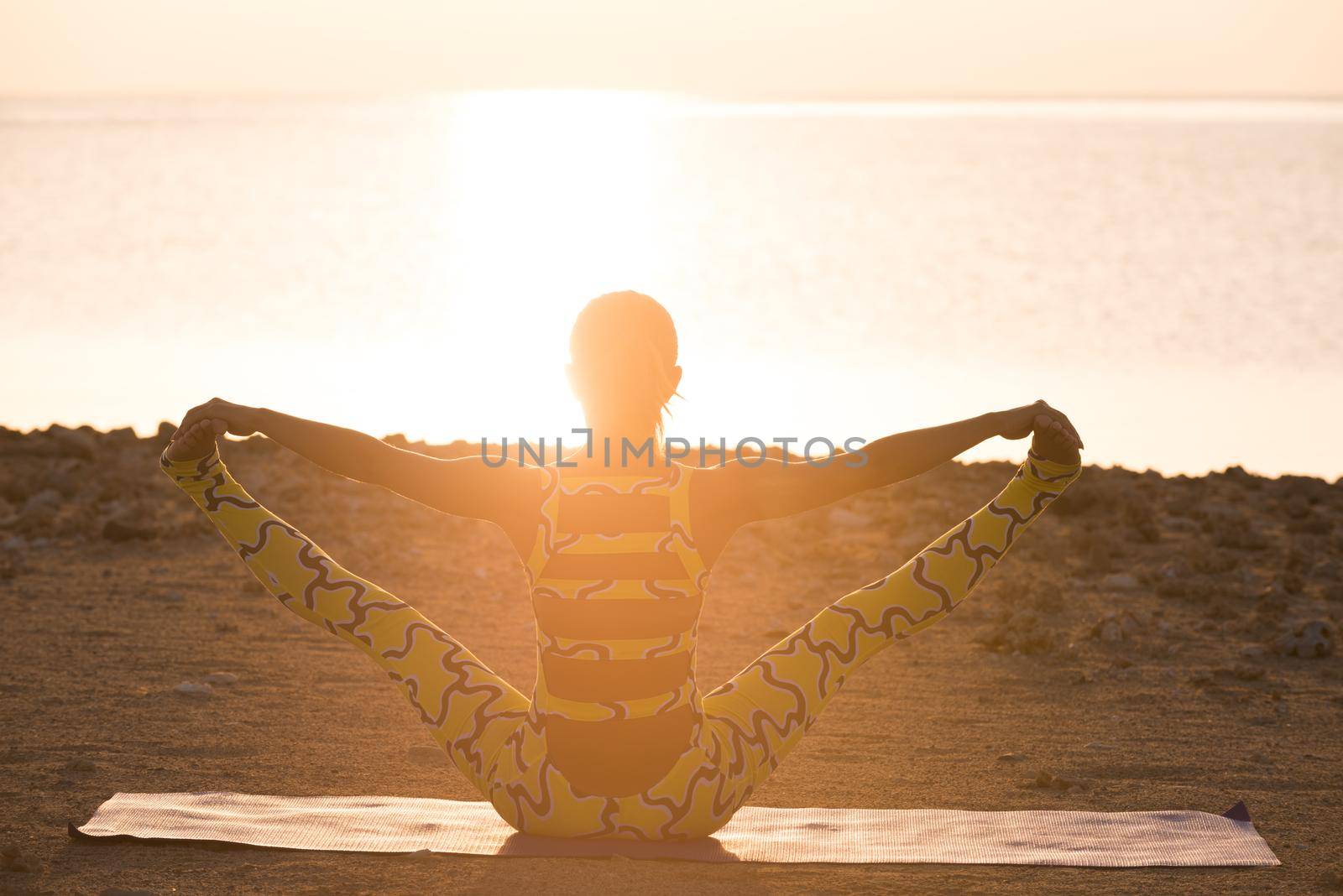 Yoga practice. Woman doing asana at sunrise by nikitabuida