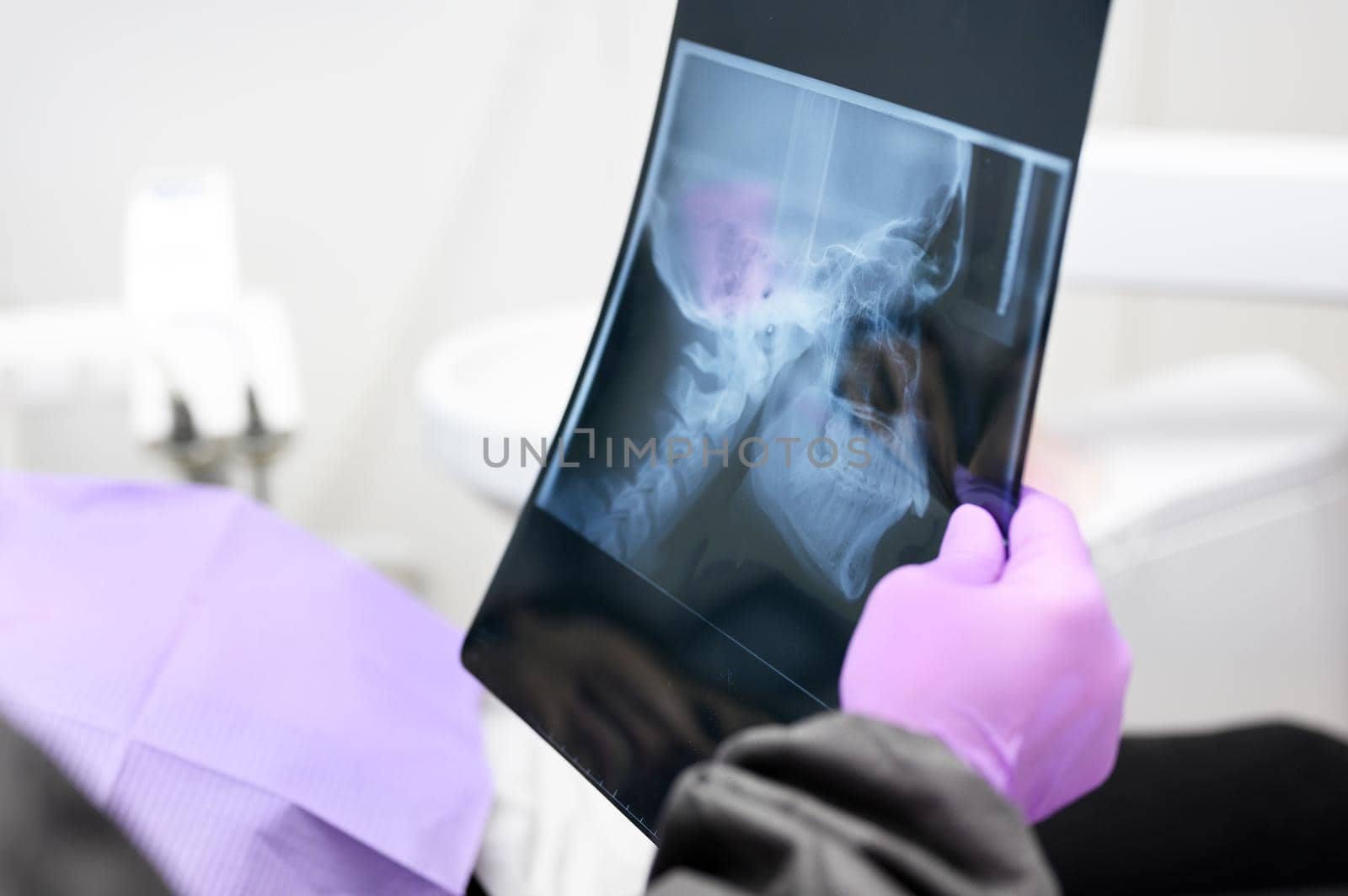 Dentist Explaining The Details Of A X-Ray Picture To Her Patient by HERRAEZ