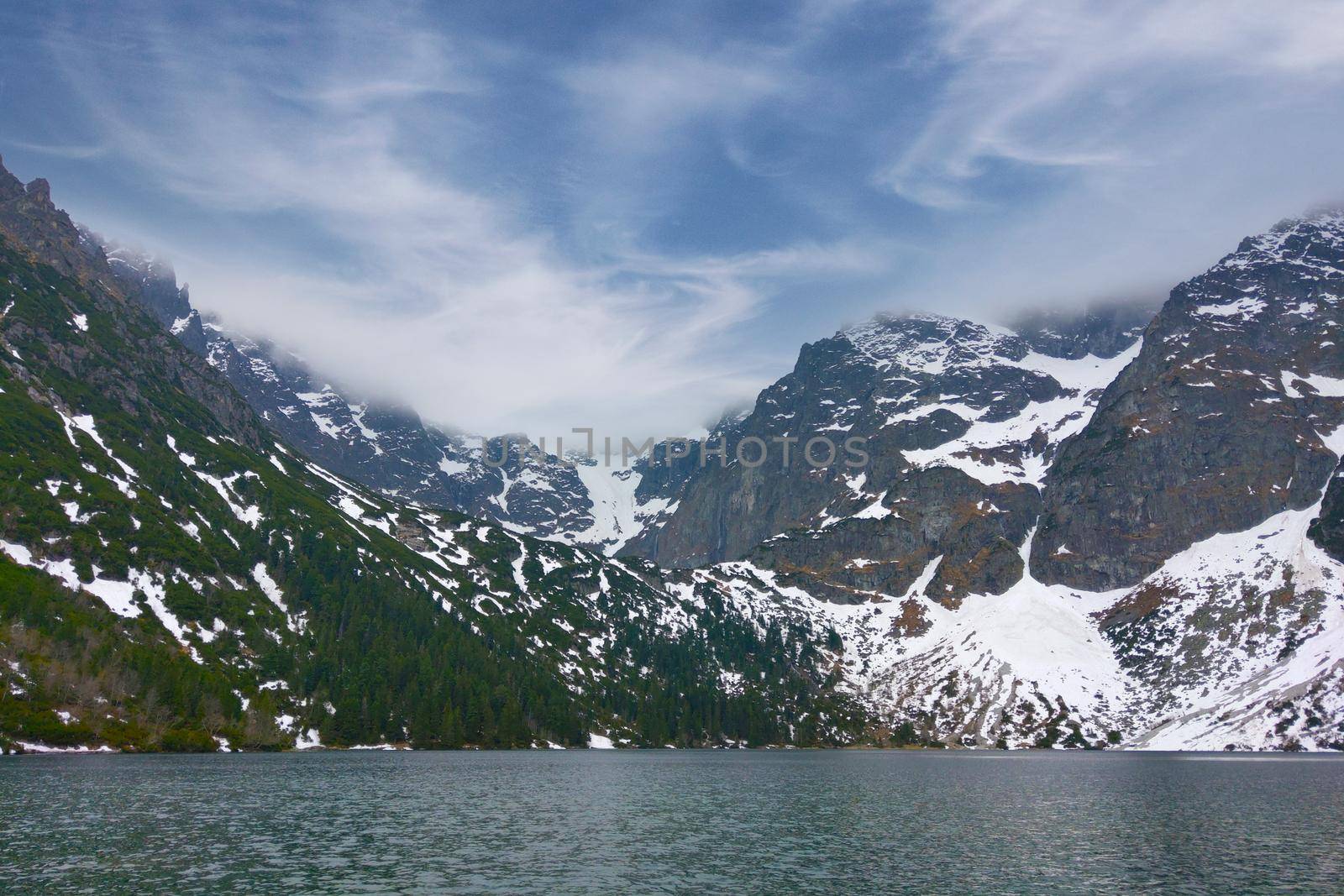 Picturesque view of the mountain lake against the blue sky