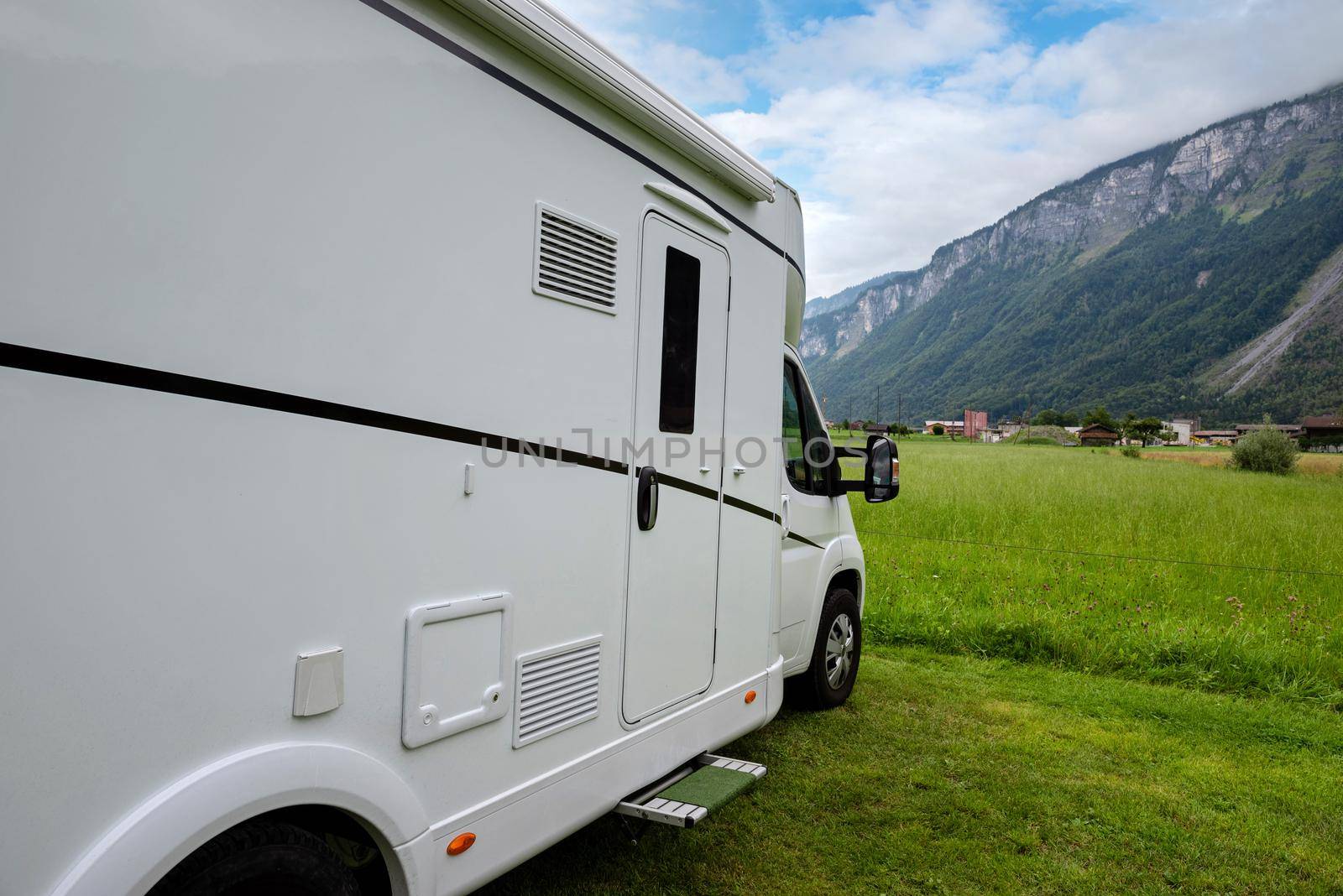 Caravan car vacation. Family vacation travel RV. Holiday trip in motorhome. Switzerland natural landscape.