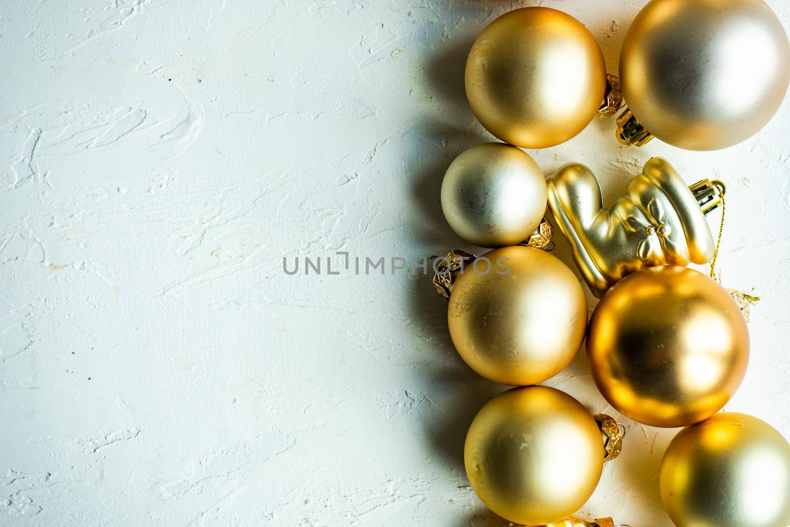 Christmas card concept with variety of holiday festive balls on concrete background