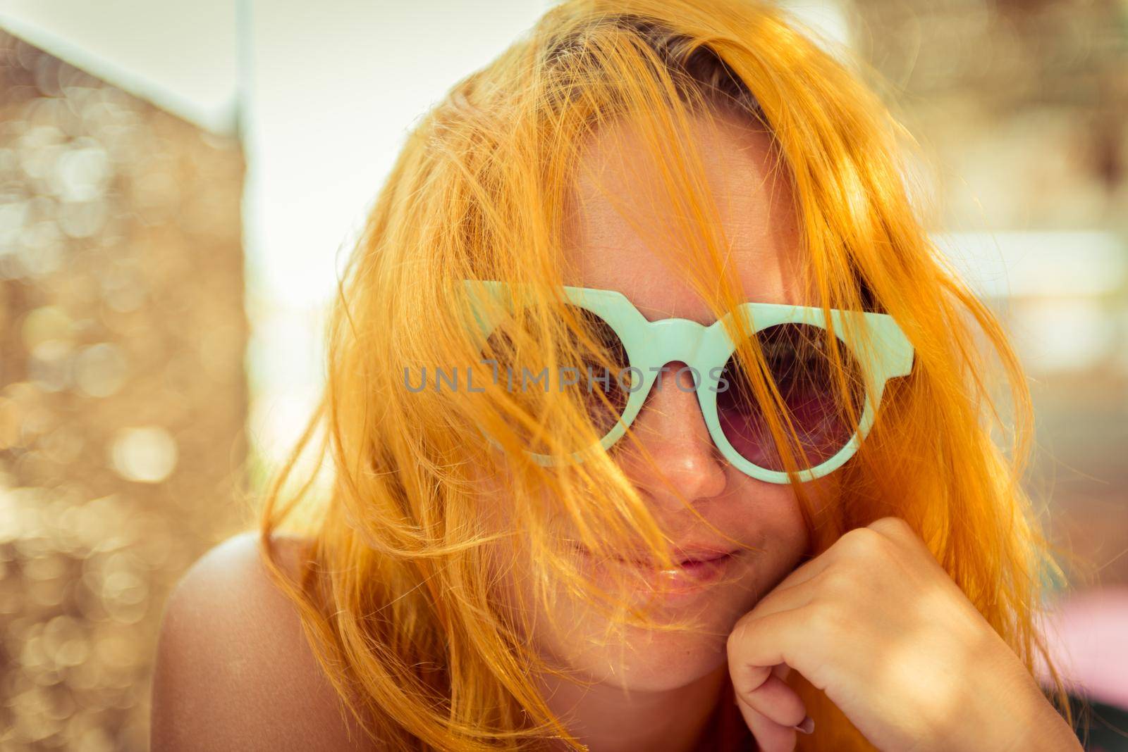 Red haired woman in beach cafe by nikitabuida