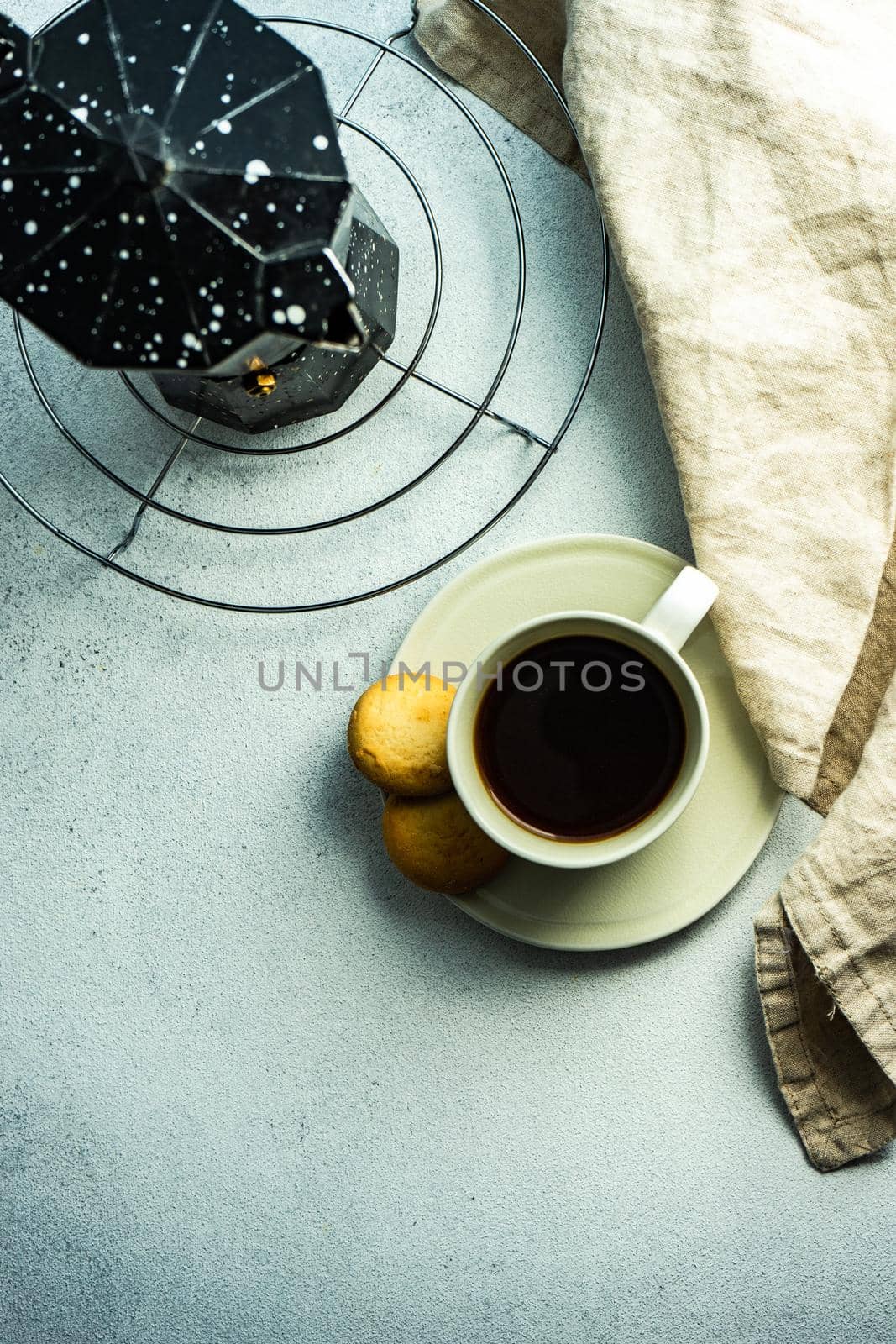 Morning cup of coffee and milk cookies served on the table