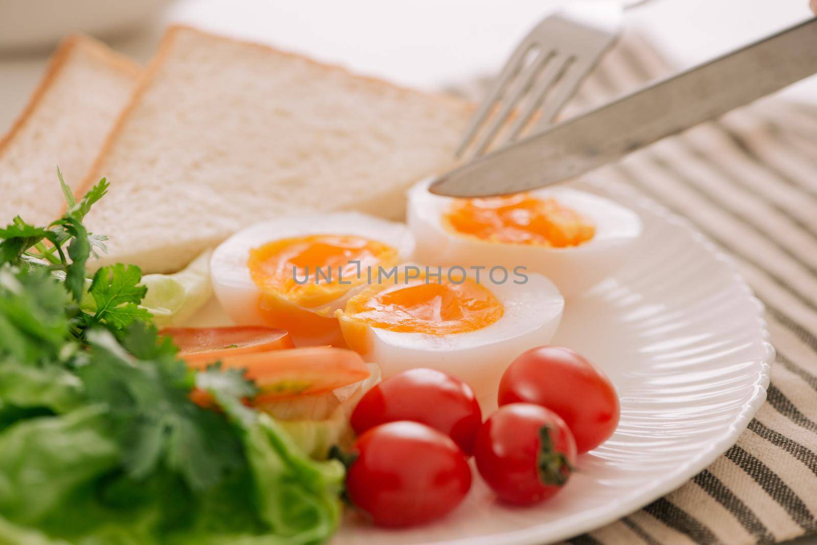Healthy breakfast or lunch. Poached egg with tomato and whole toast. Selective focus. Healthy eating, healthy lifestyle concept by makidotvn