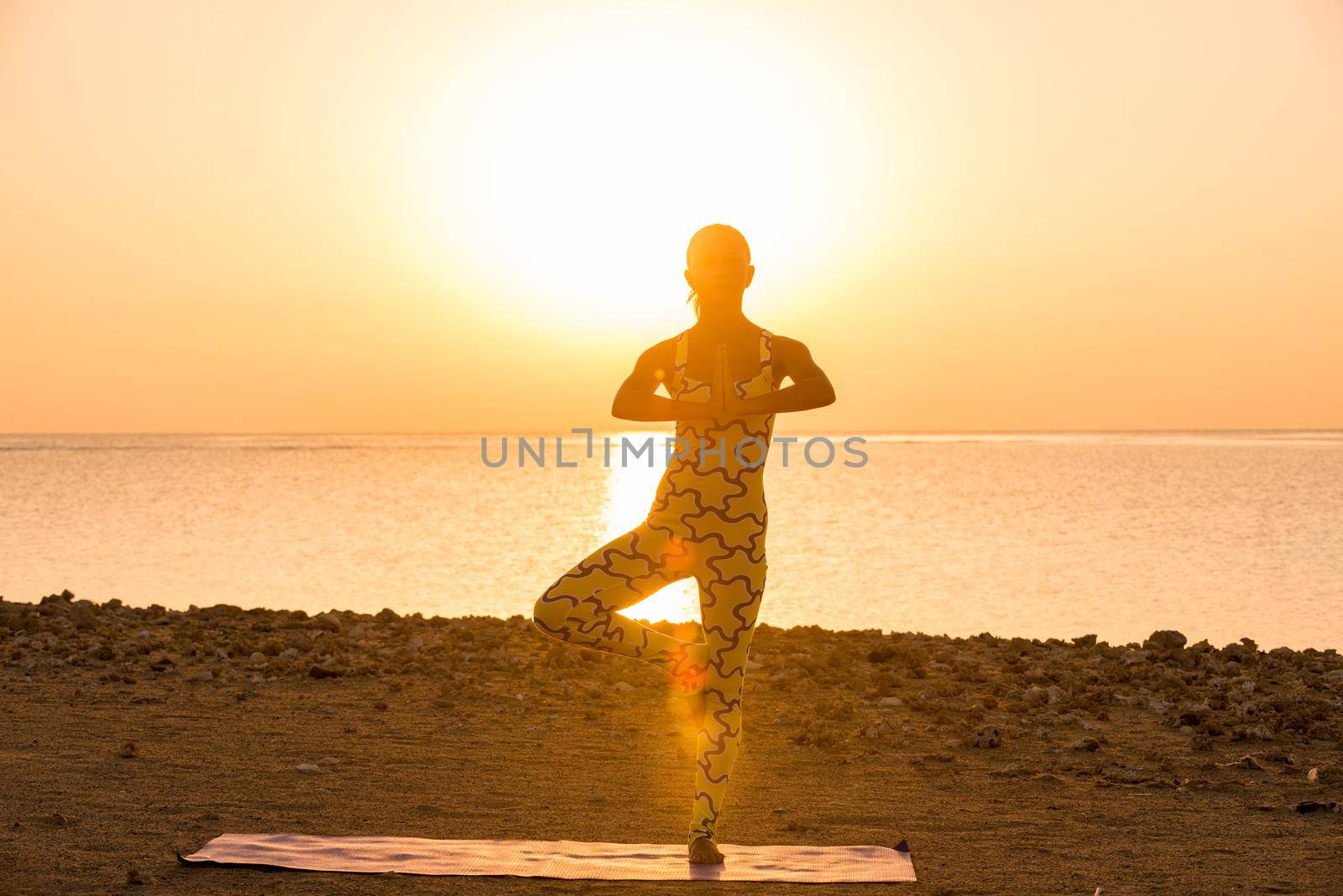 Yoga practice. Woman doing asana at sunrise