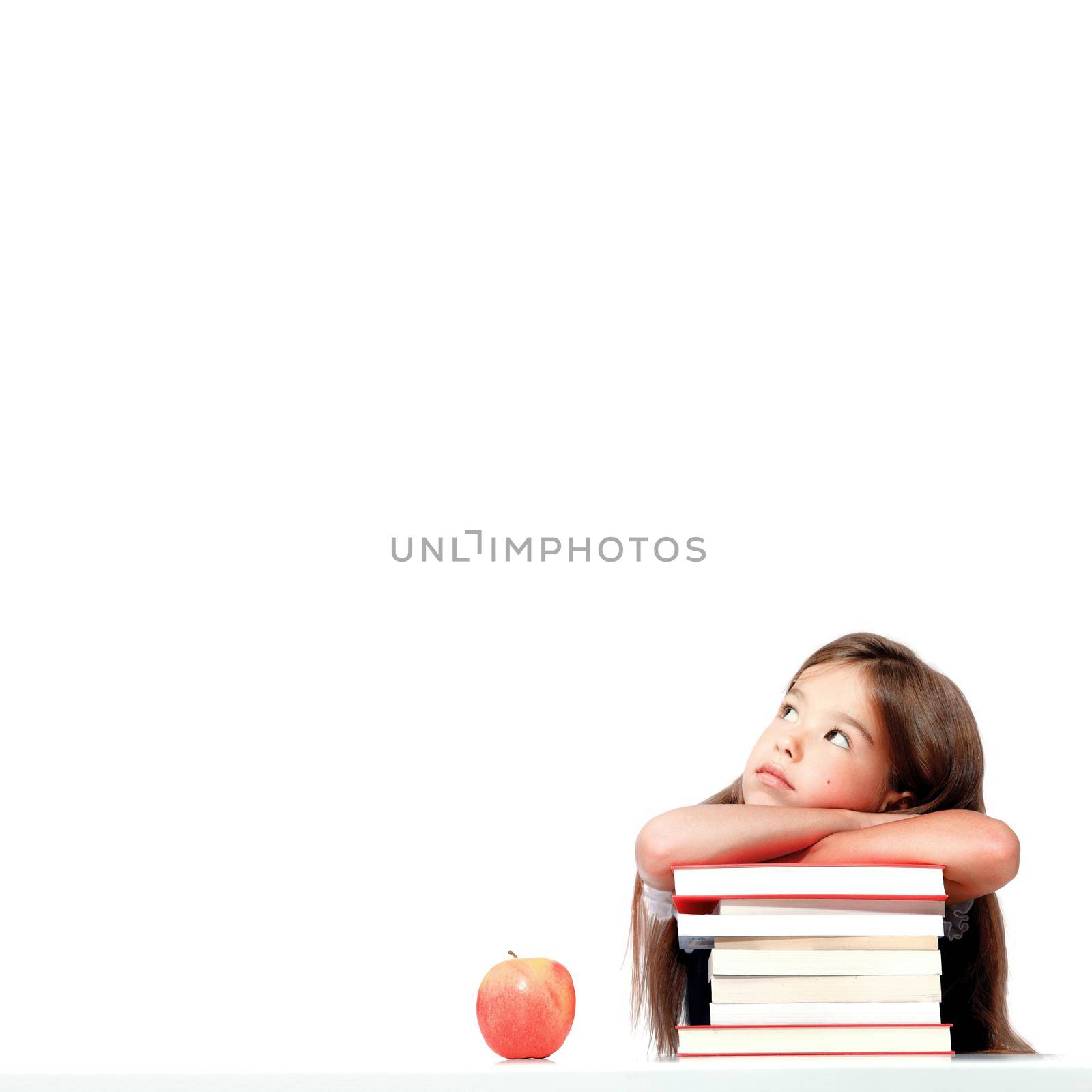 Cute little child girl looking up on the desk at school. by Taut