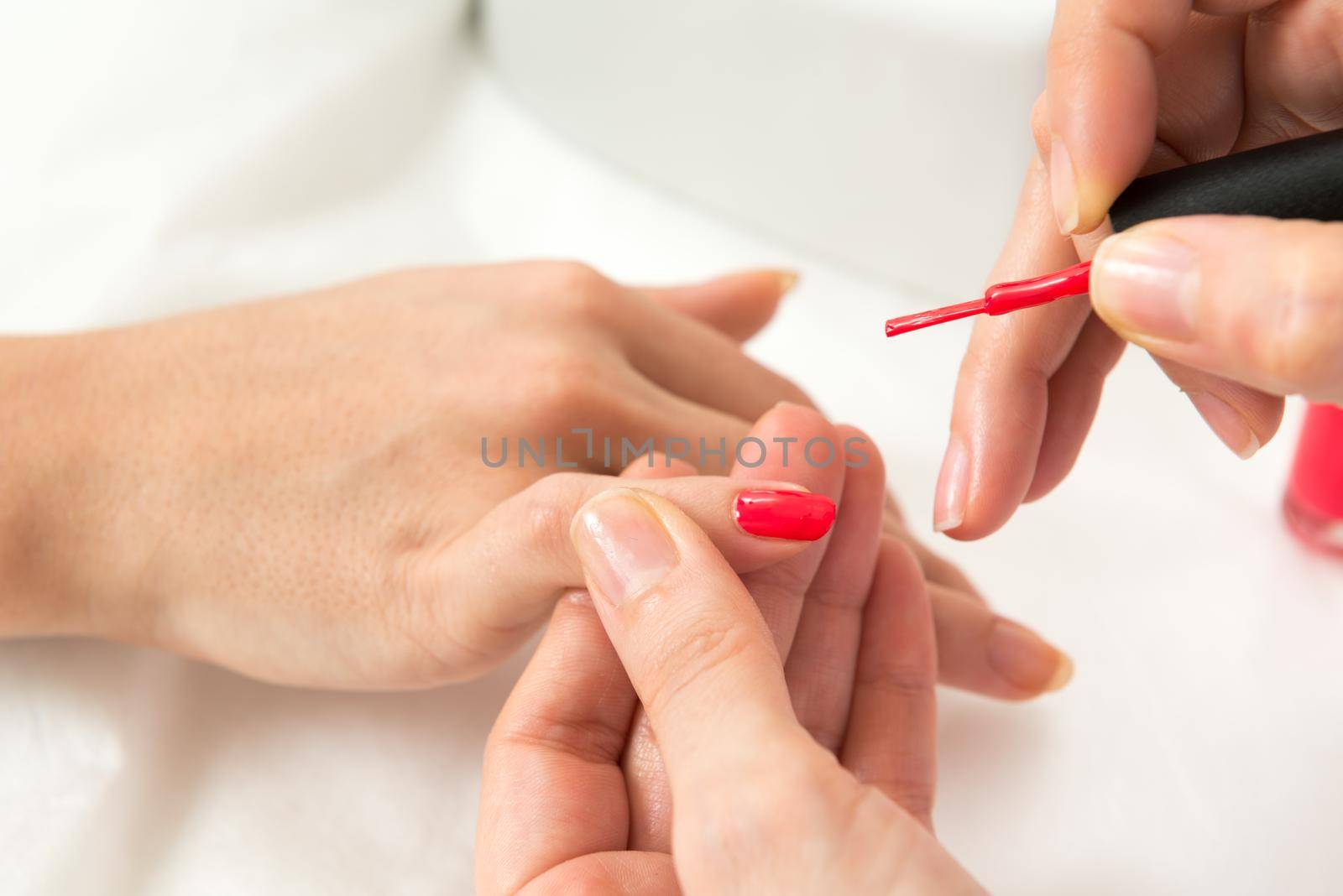 Manicure process in beauty salon close up of female hands