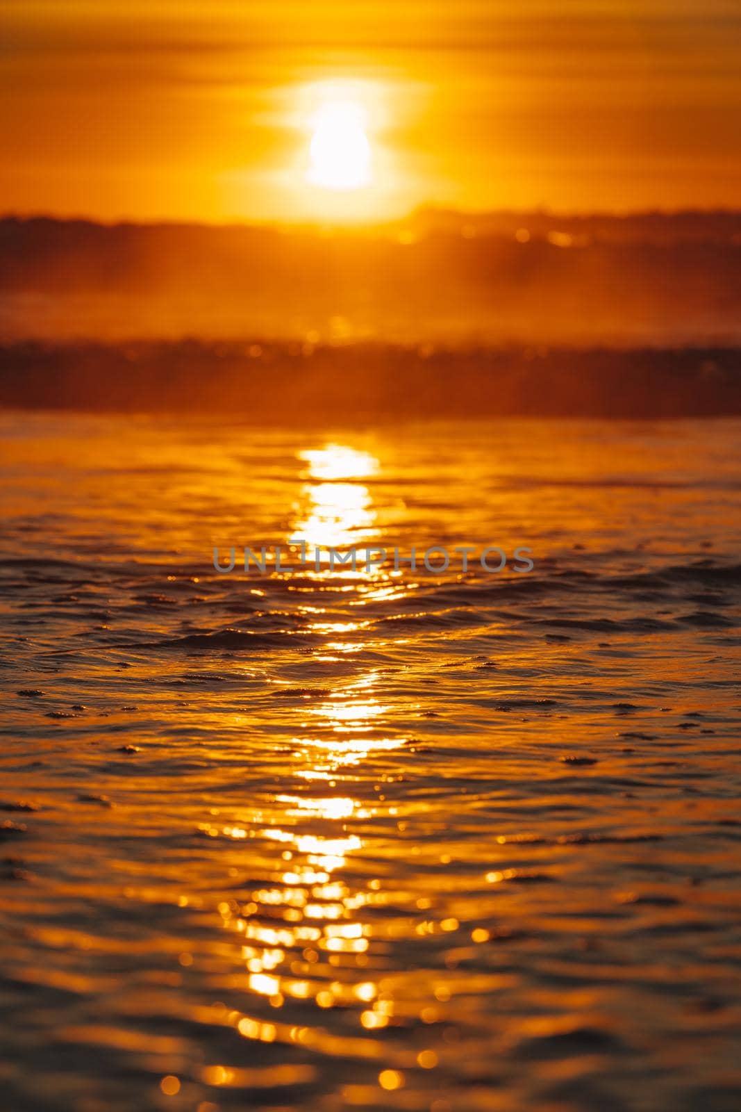 Colorful ocean beach sunrise with deep blue sky and sun rays. by braydenstanfordphoto