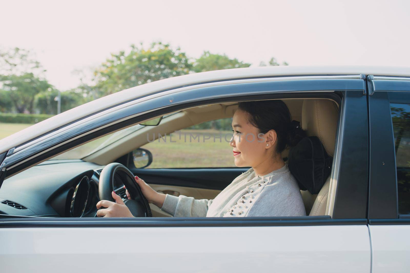 Happy Asian woman driving travel by herself. by makidotvn