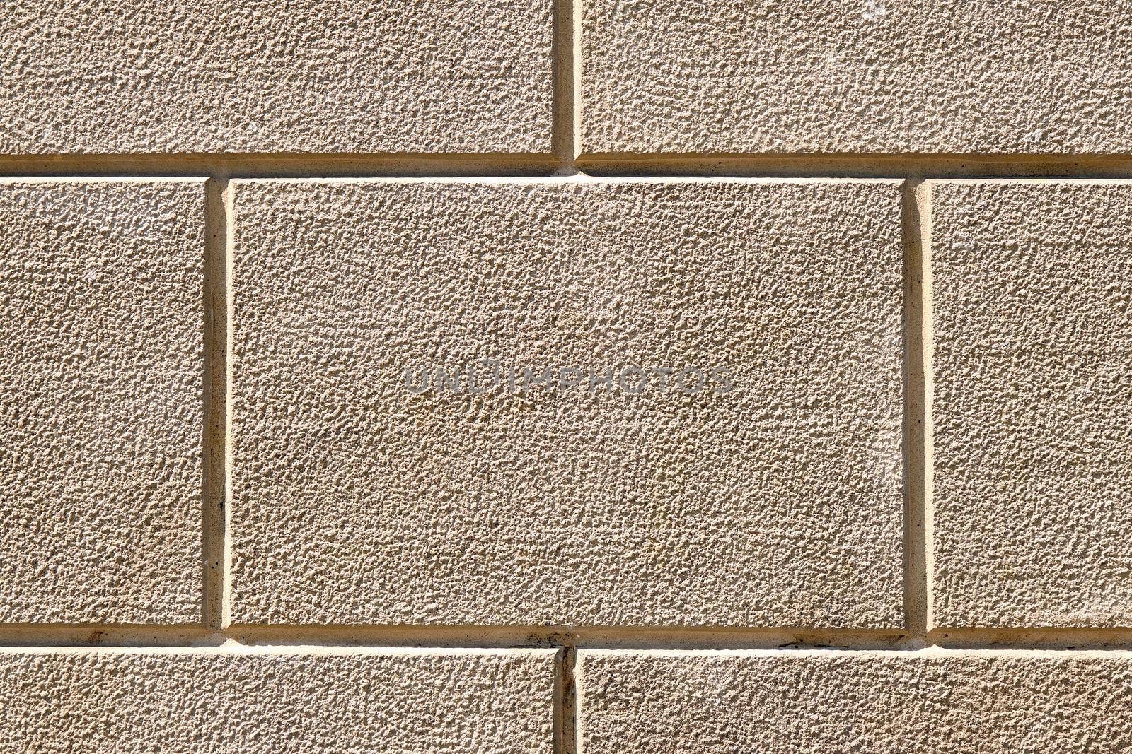 Background from a wall with rectangular beige stone slabs