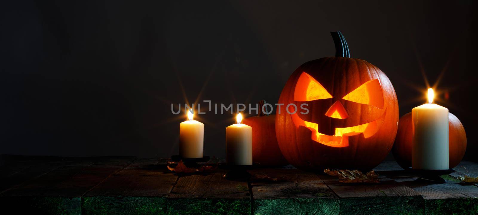 Halloween pumpkin with cut face and candles dark holiday card