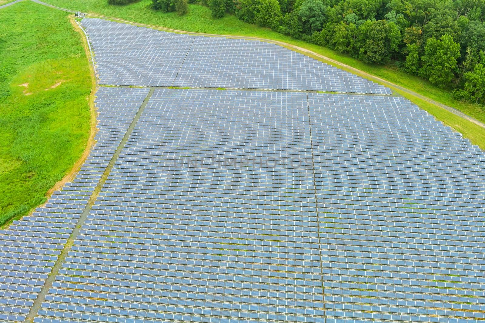 Aerial view of solar panels with renewable green alternative energy by ungvar