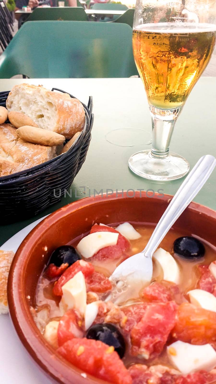 Cold beer, Murcian salad and bread on the terrace of a bar in Spain