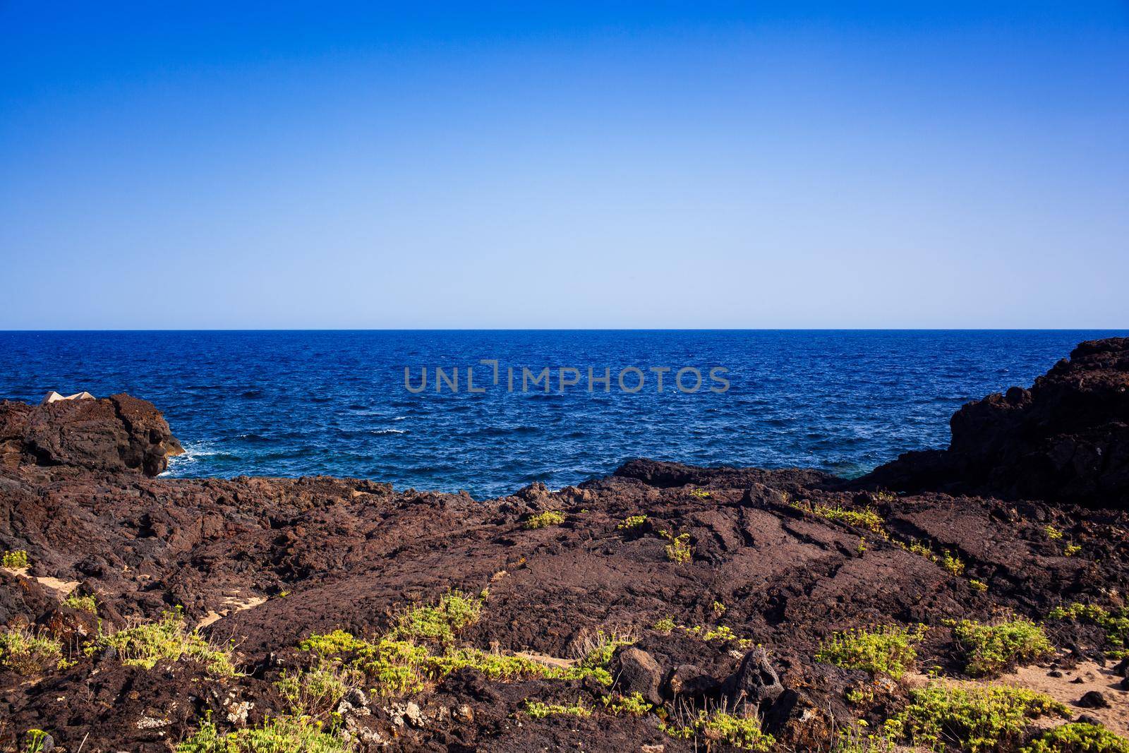 View of the scenic lava rock cliff in the Linosa island. Sicily by bepsimage