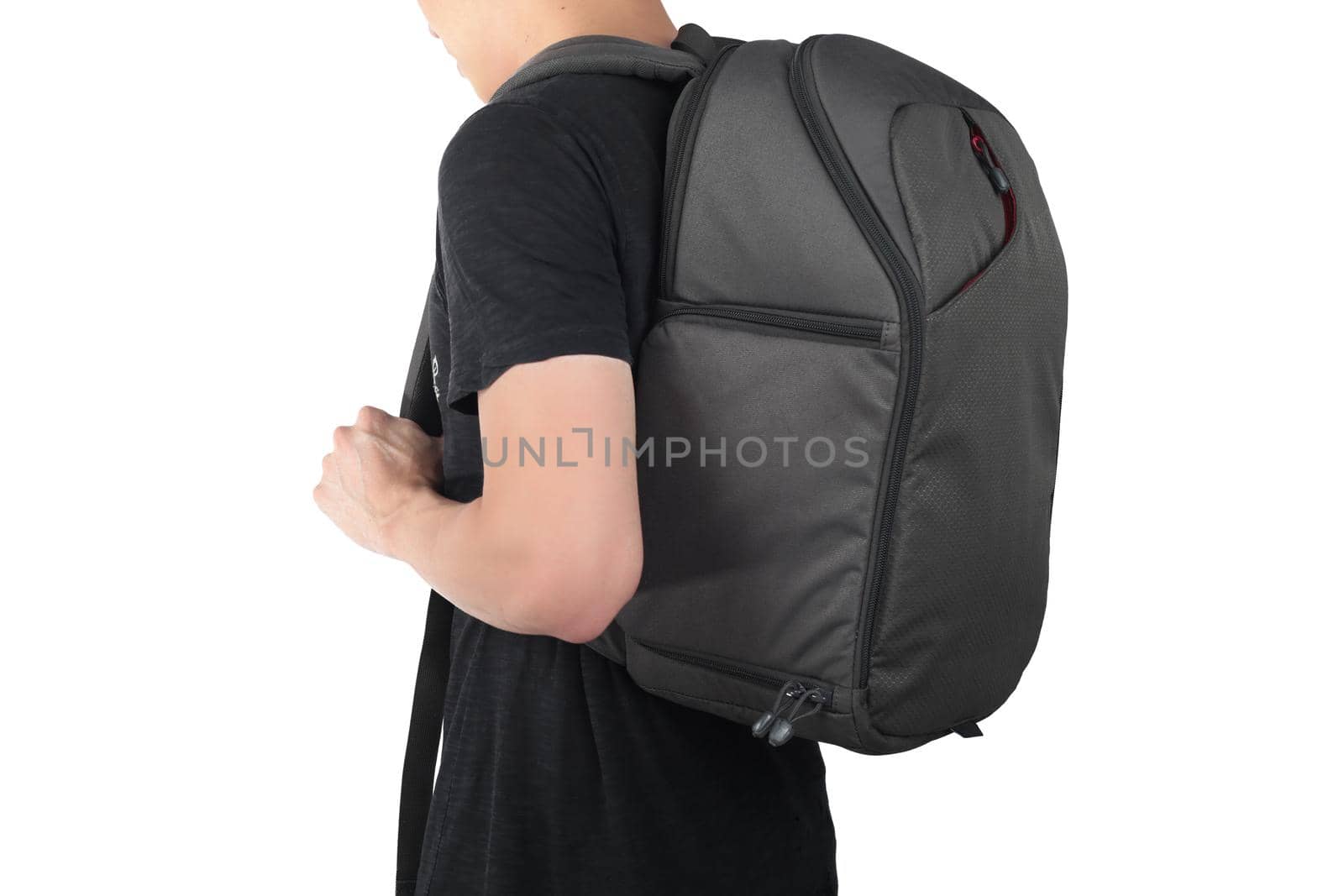Young man standing with travel backpack equipments isolated white background