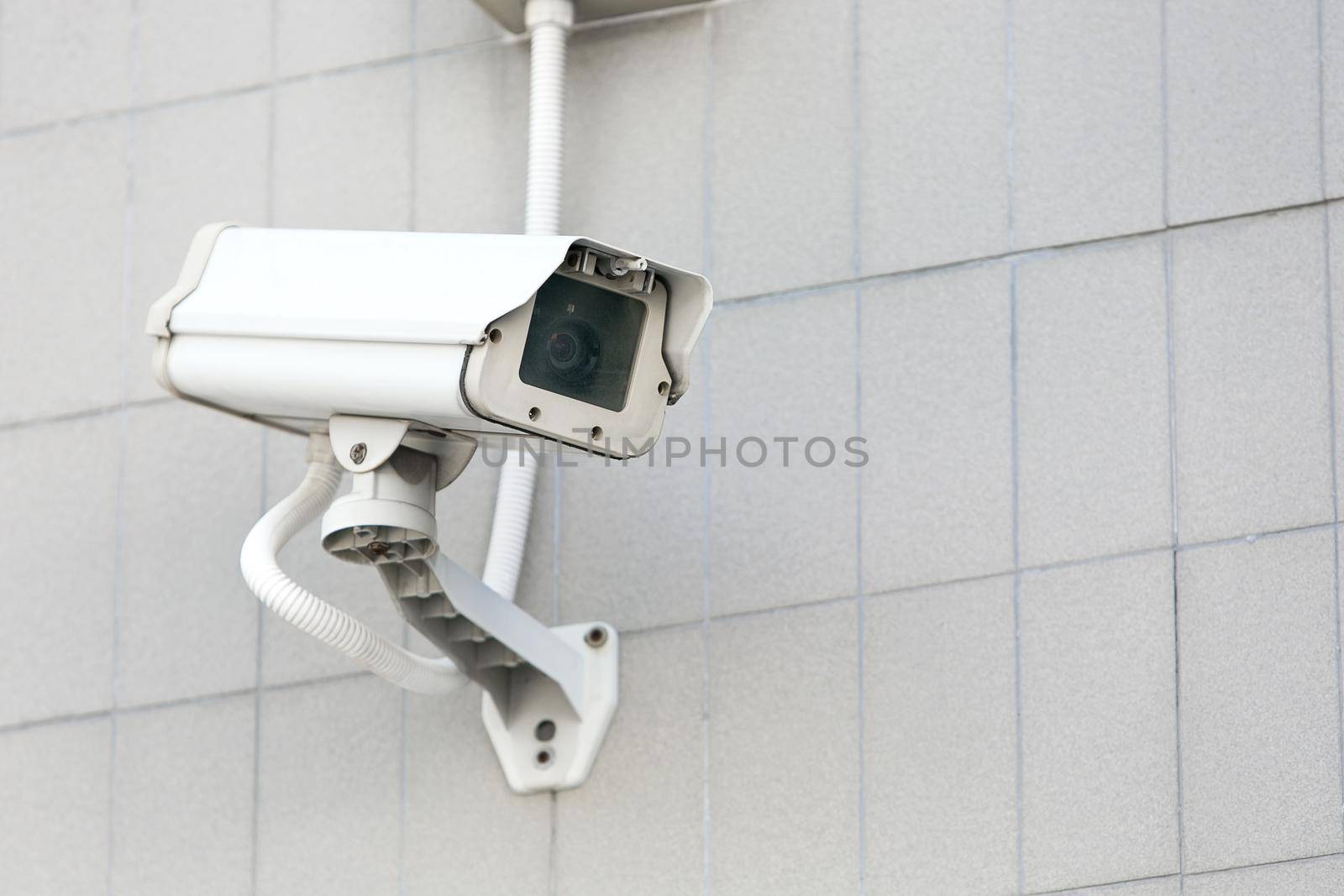 CCTV camera on the wall high building. by jayzynism