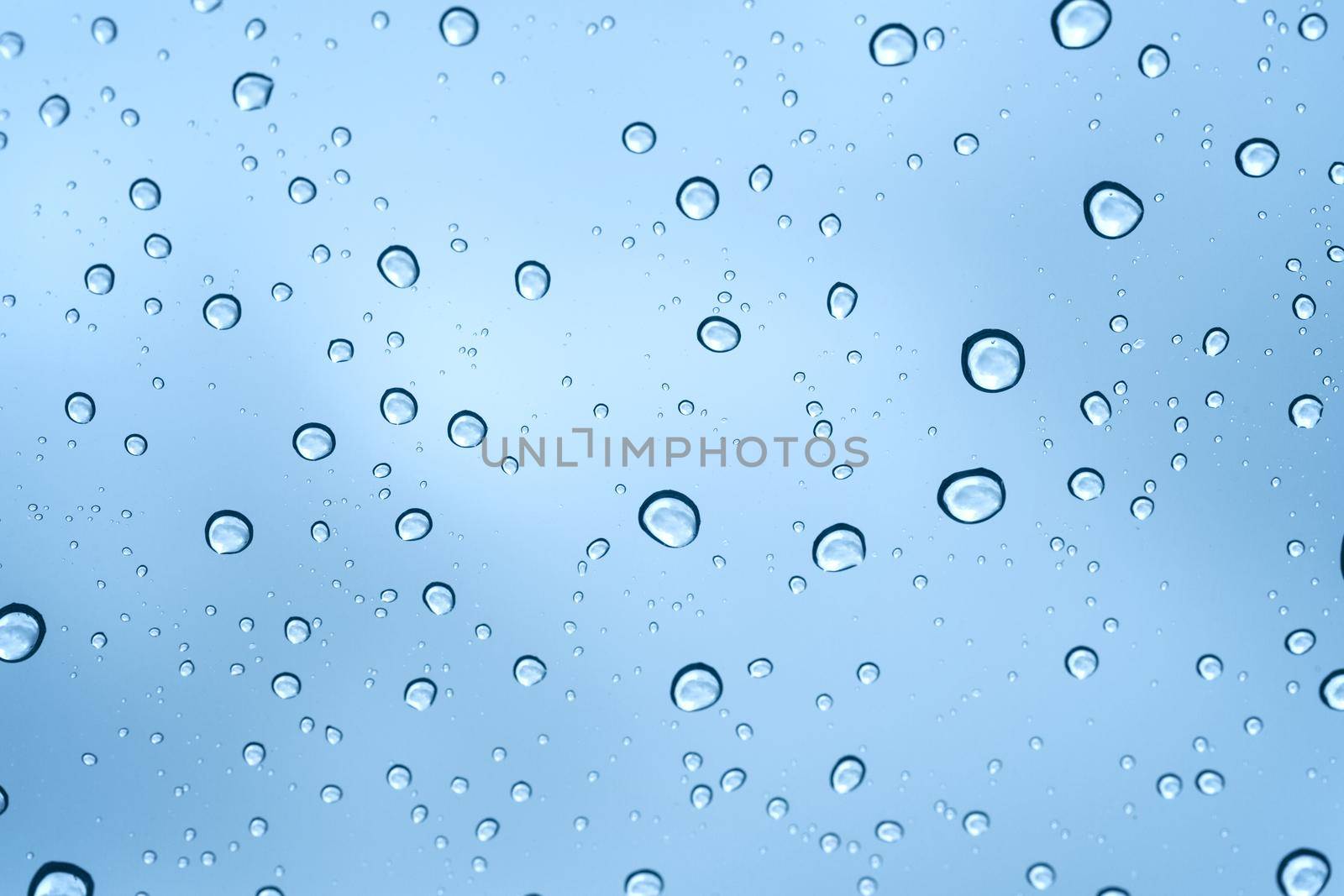 Rainy water drop on glass mirror background.