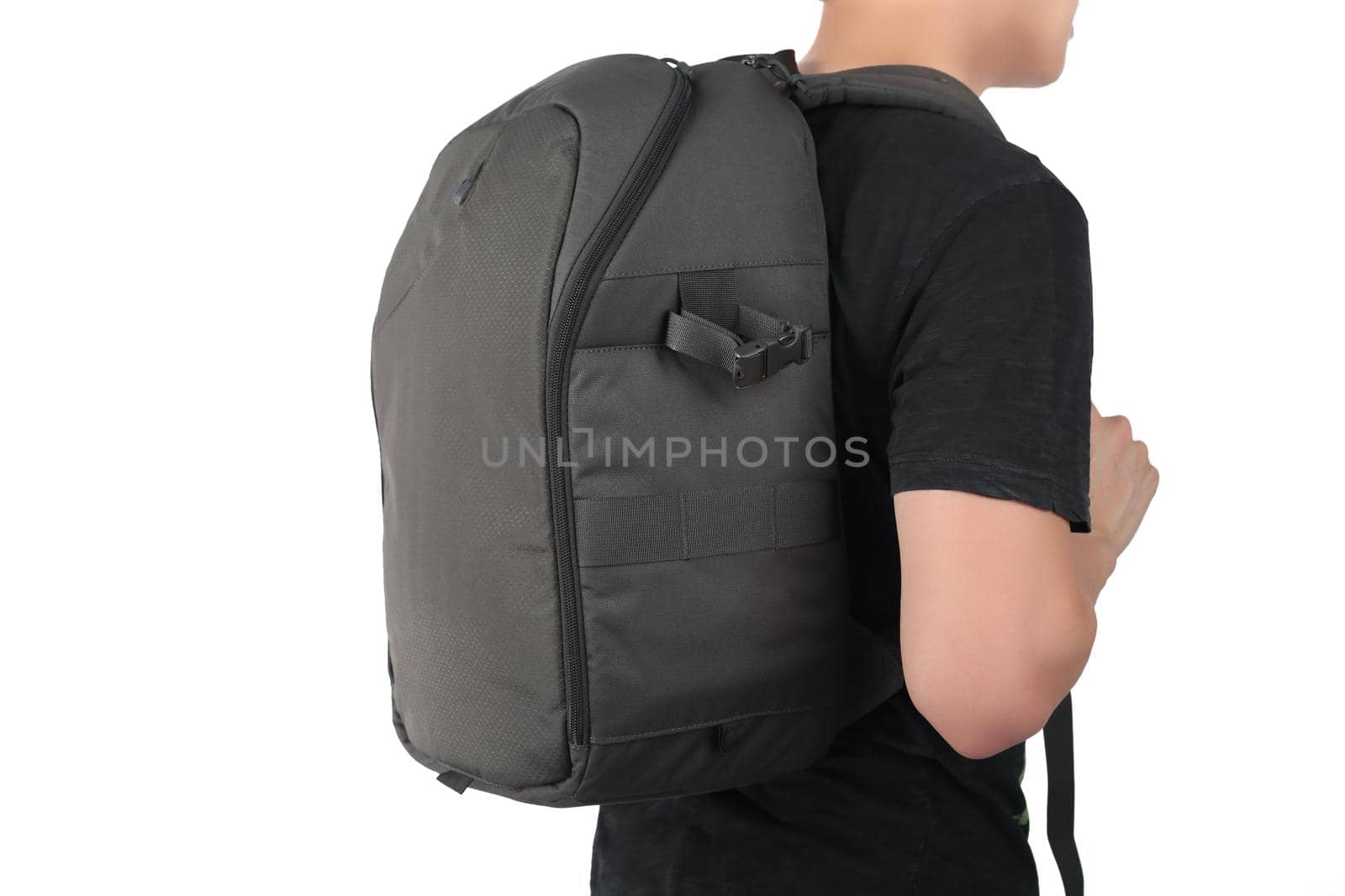 Young man standing with travel backpack equipments isolated white background