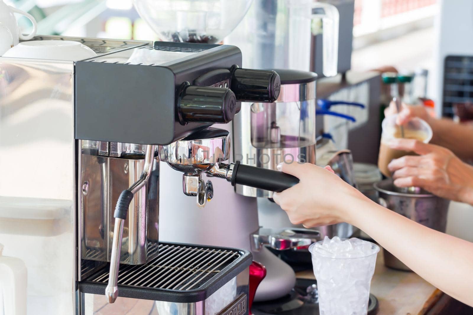 Hand make a latte cup of coffee machine.