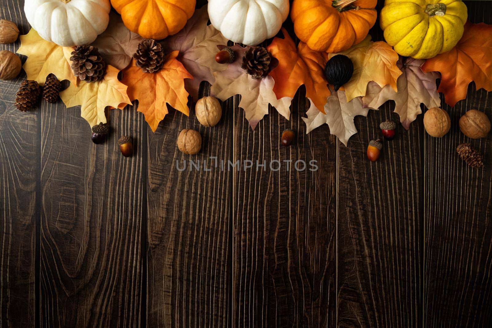 Happy Thanksgiving Day with pumpkin and nut on wooden table