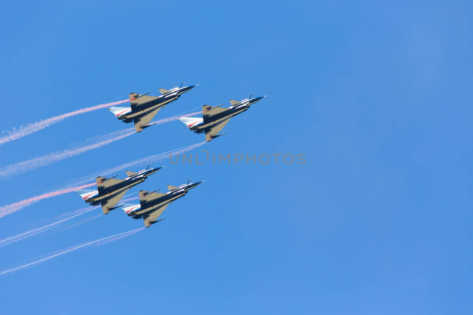 Nakhonratchasima, THAILAND November 26, 2015 : F16 Gripen and August 1st Aerobatic team" engaged in acrobatics. by jayzynism