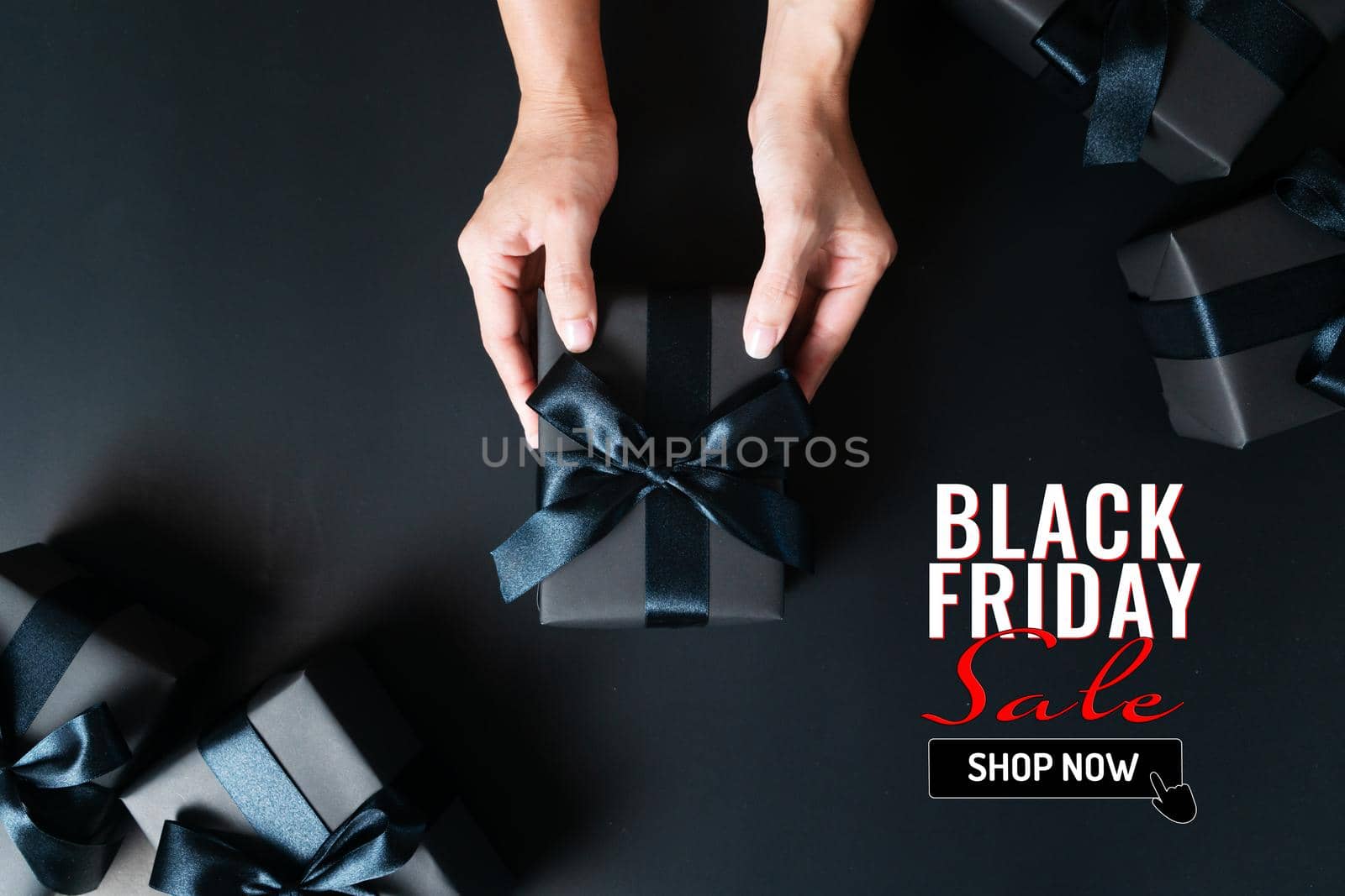 black friday sale, woman hand give the gift box on black background by psodaz