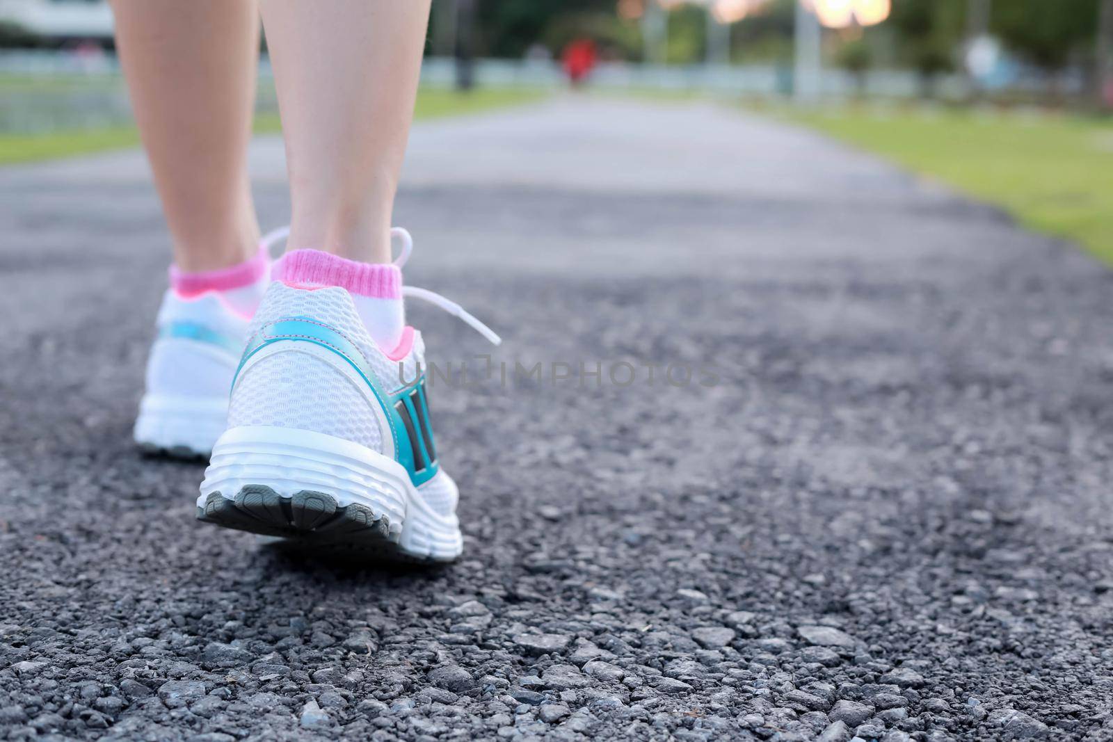 Close-up women jogging at  public park in the morning. by jayzynism