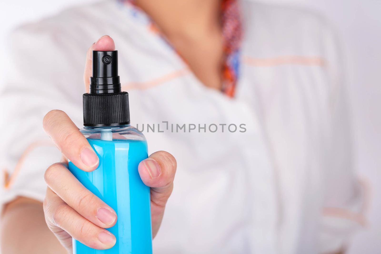 Women holding spray blue bottle.