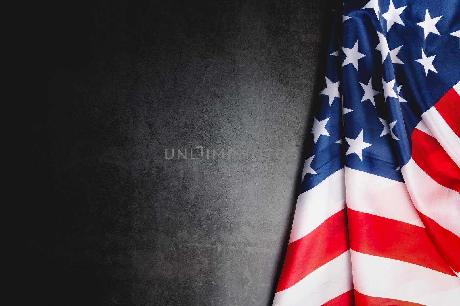 Veterans day. Honoring all who served. American flag on gray background with copy space.