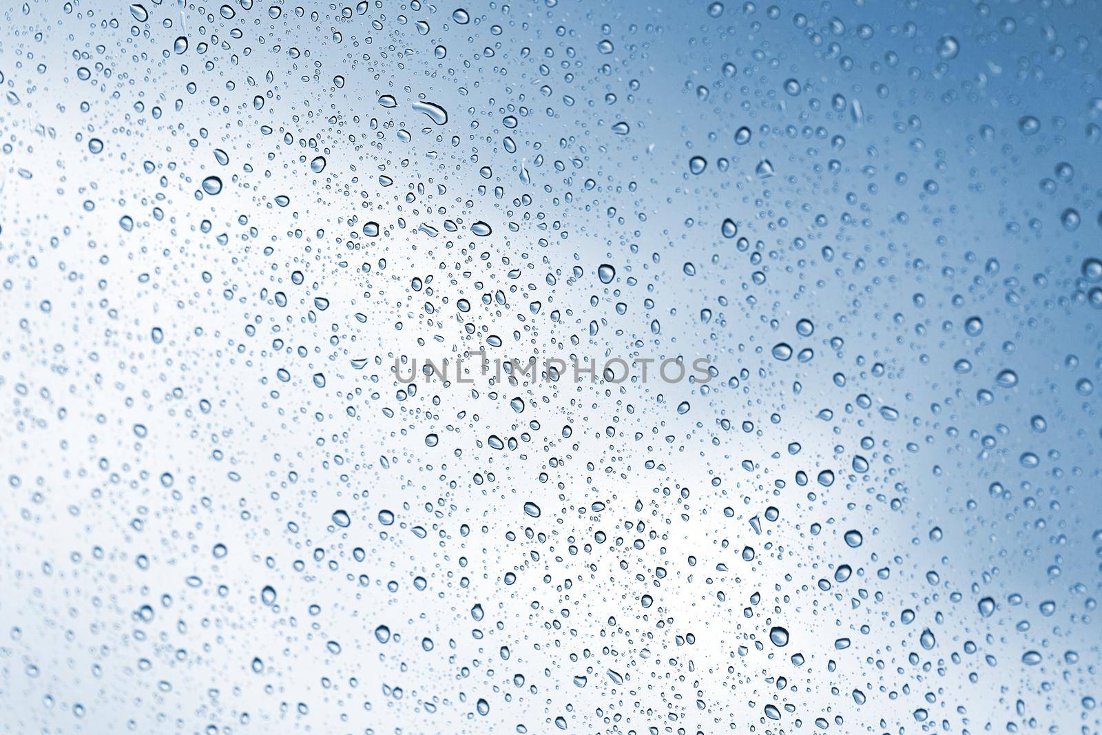 Rainy water drop on glass mirror background.