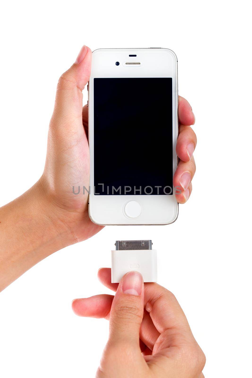 Female holding USB port charger connect to smart phone.