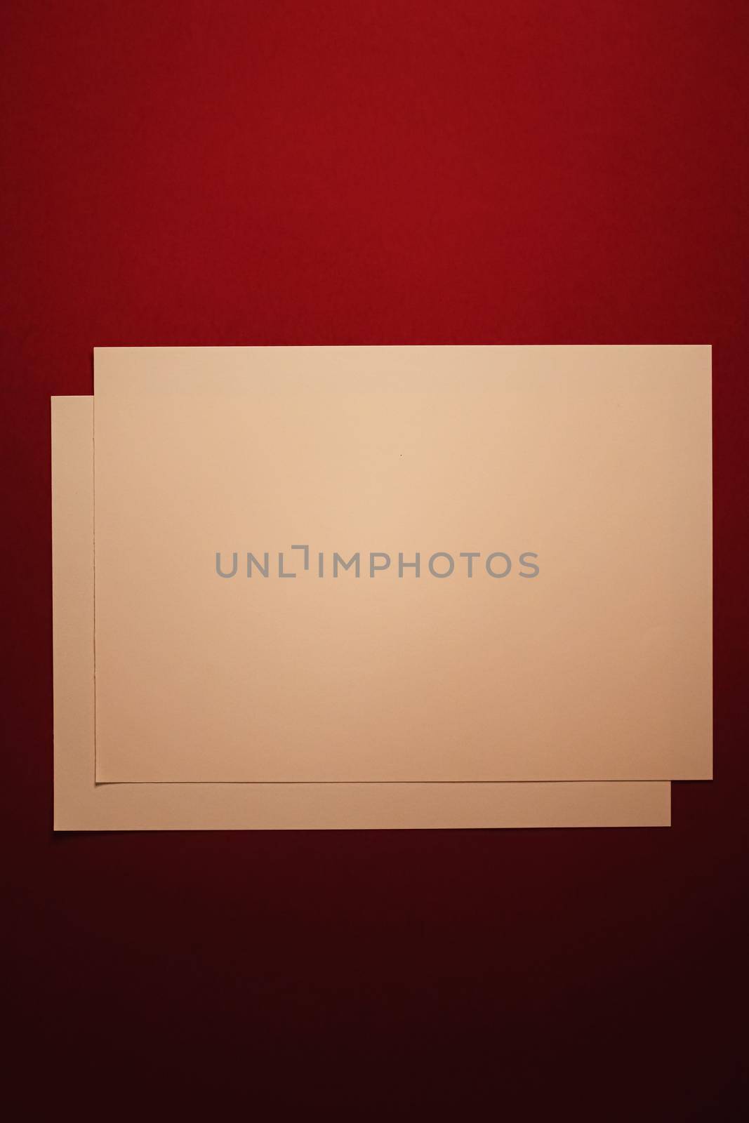 Blank A4 paper, beige on dark red background as office stationery flatlay, luxury branding flat lay and brand identity design for mockup by Anneleven