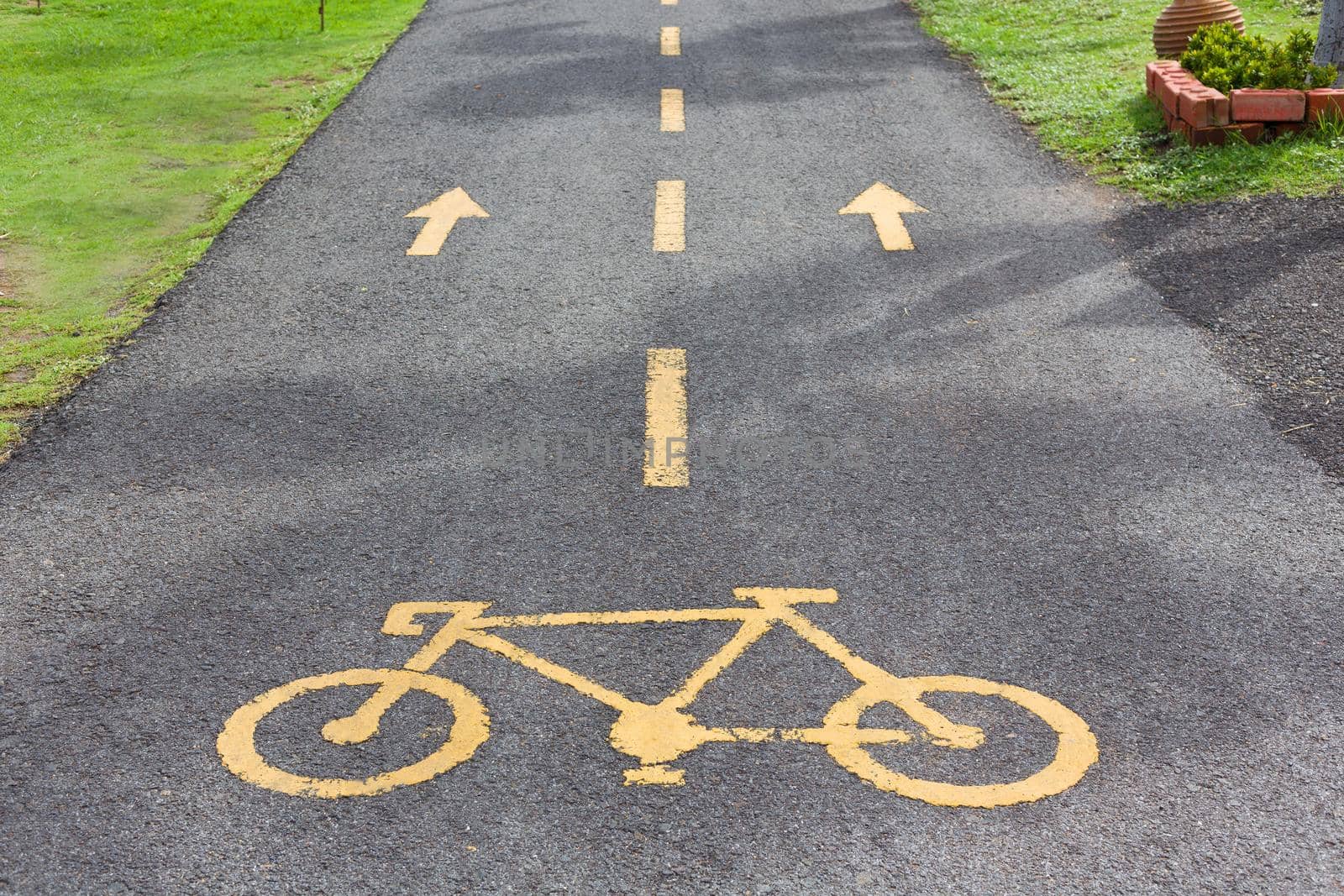 Bicycle sign in public park area. by jayzynism