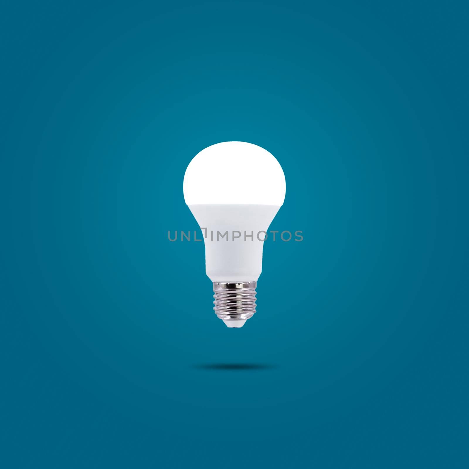 LED energy saving lamp 230v isolated on blue pastel color background. by wattanaphob