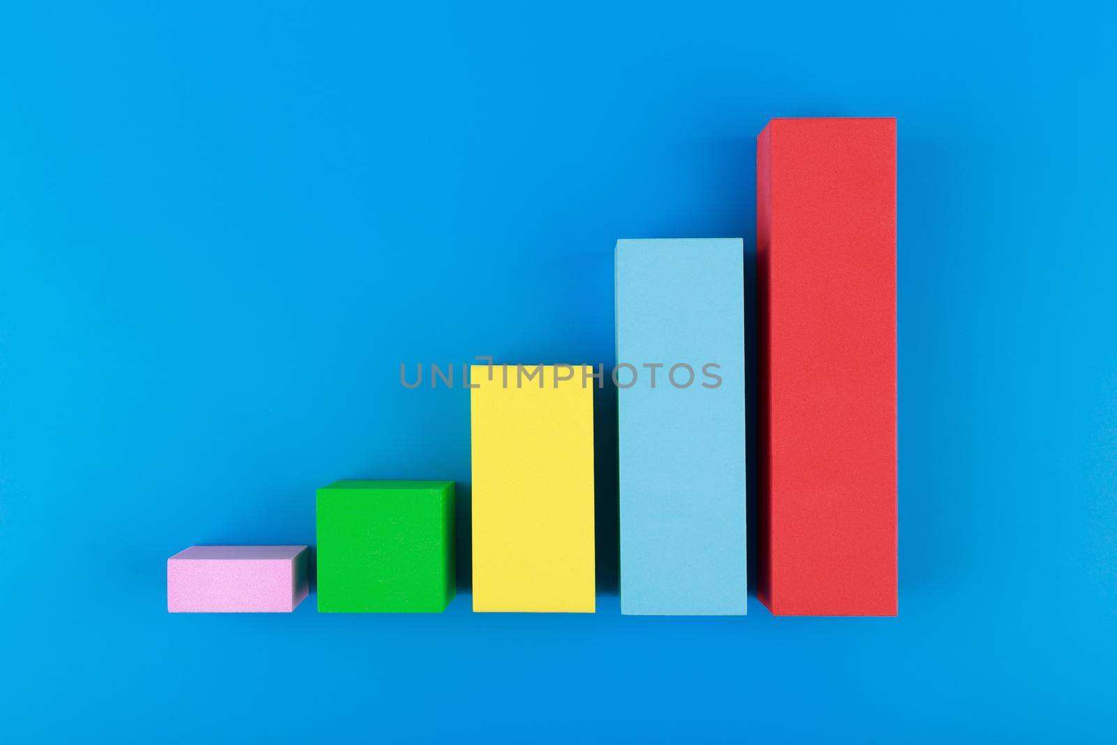 Business concept. Multicolored graph diagram with rise against blue background. Chart marketing, annual or corporate report, sales or growth evaluation or analytic or profit growing