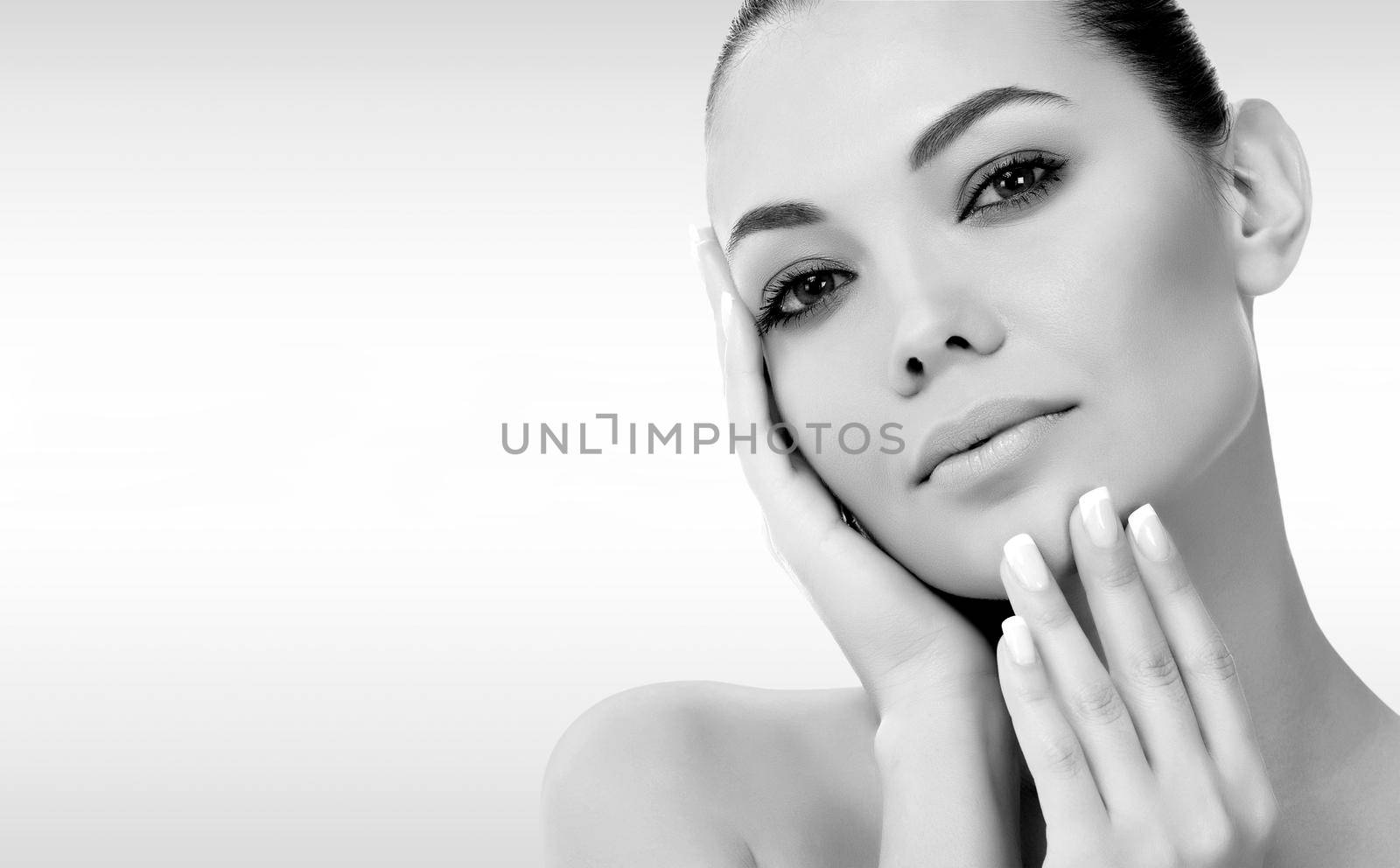 Pretty woman against a grey background with copyspace