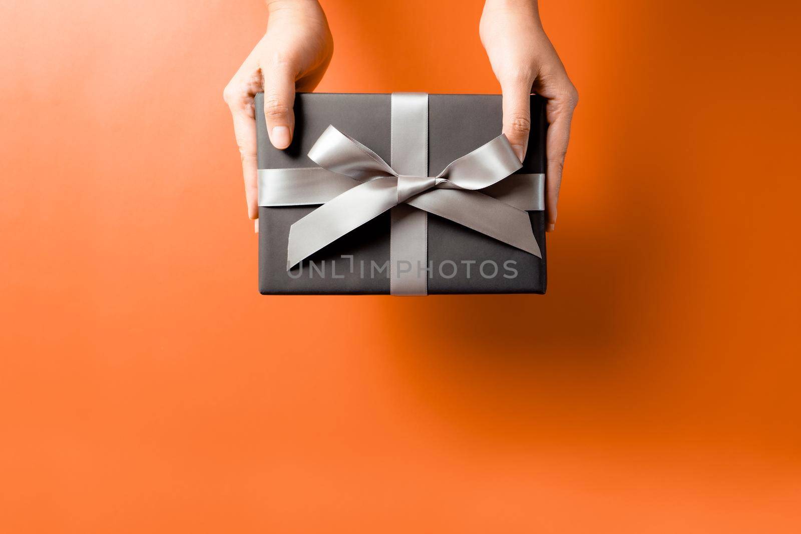 young woman hand with a gift box offer to receiver by psodaz