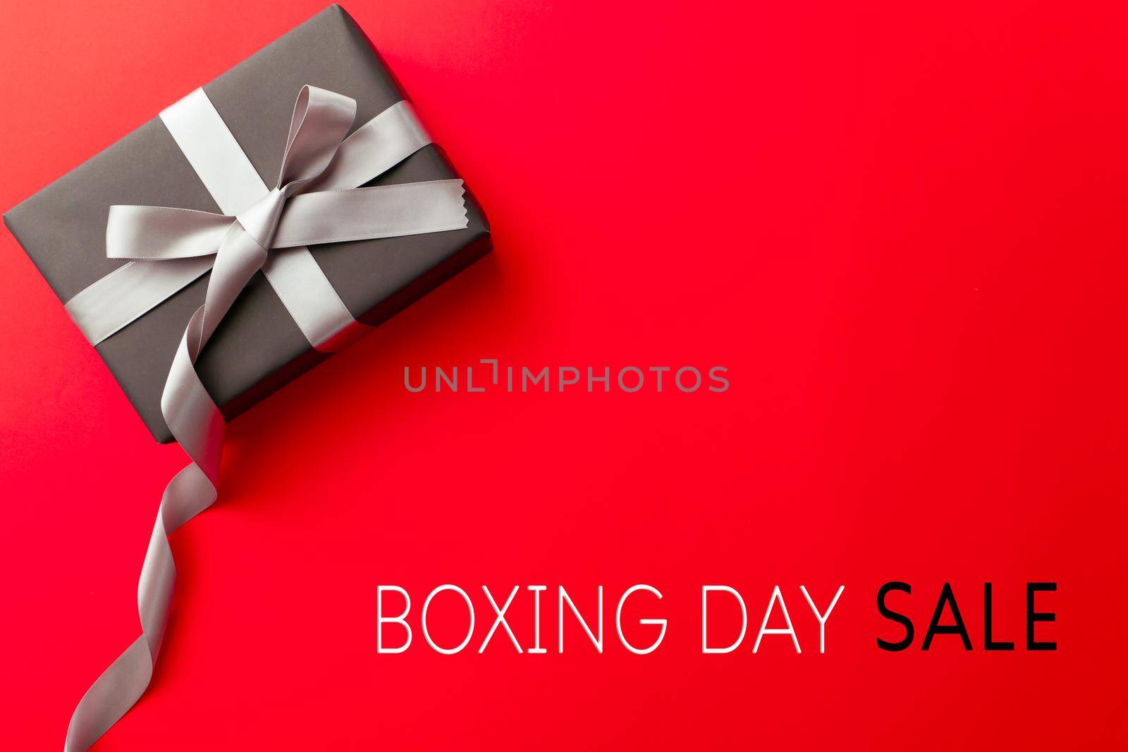 Boxing Day sale, a gift box on red background