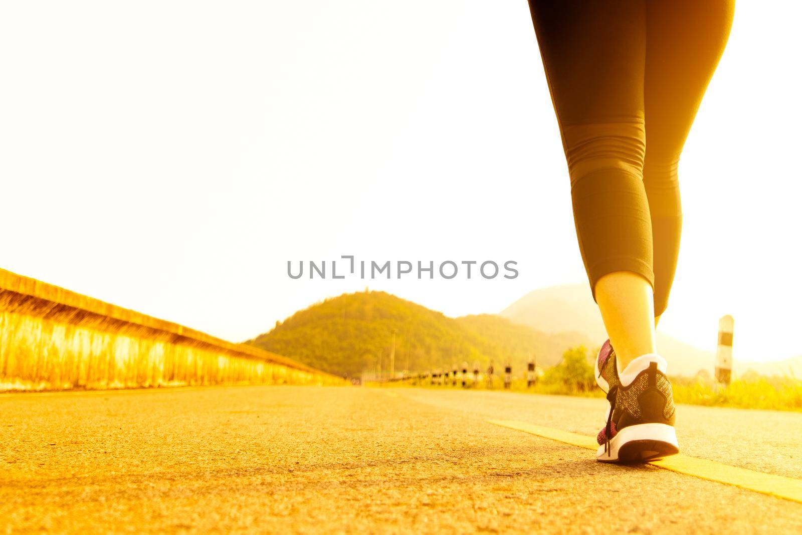 sport woman walking towards on the road side. Step concept by psodaz
