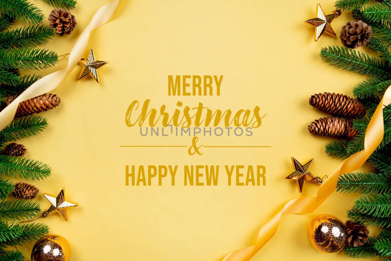 Christmas background, pine tree with xmas decoration on yellow background